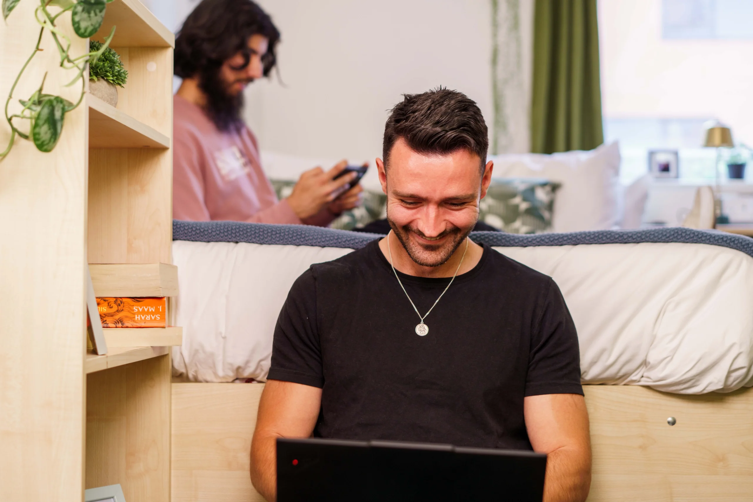 20% alumini discount - man smiles down at laptop