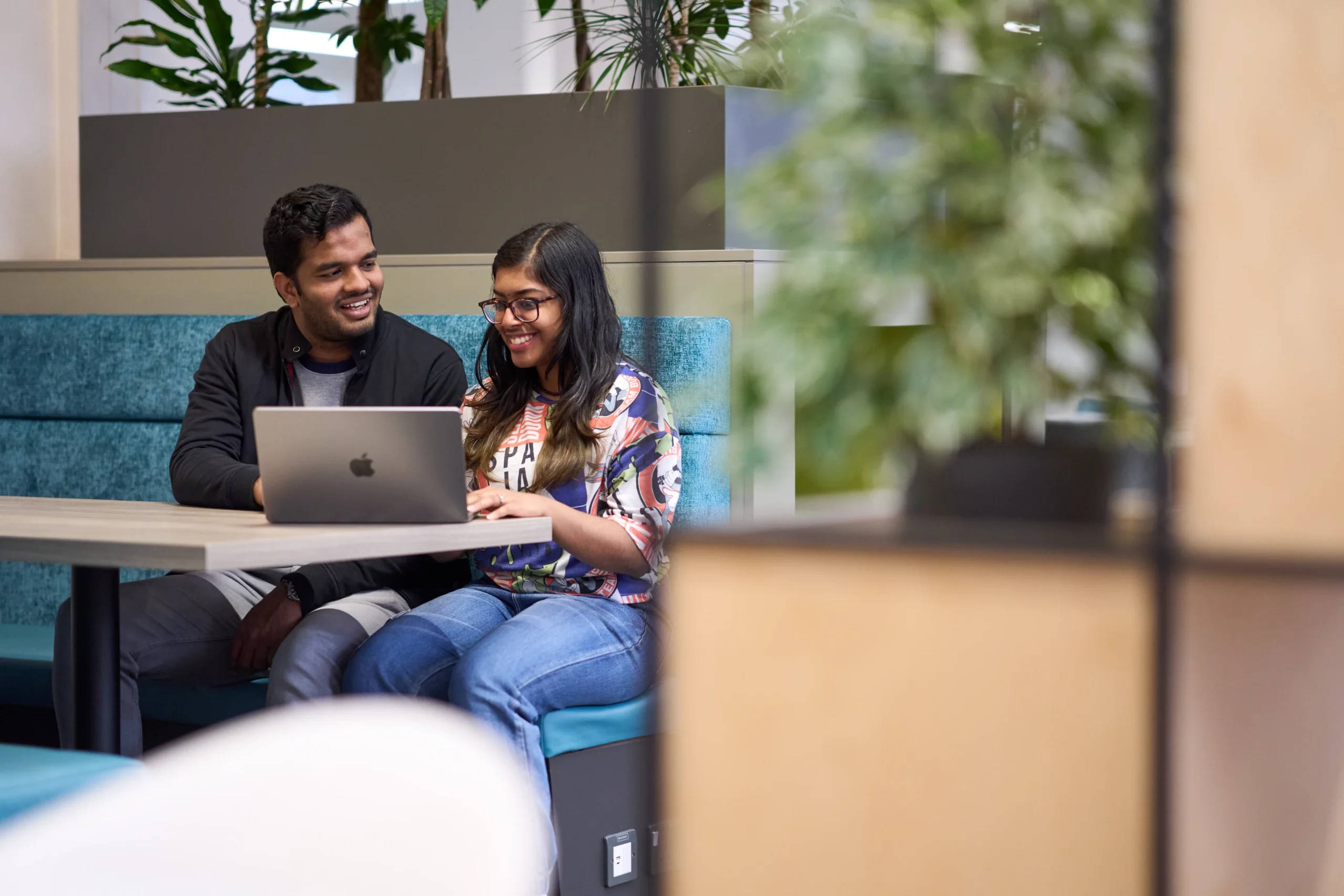 Alternative entry routes into undergraduate and postgraduate programmes at Aston University Online - Two students sharing a laptop in a co-working space