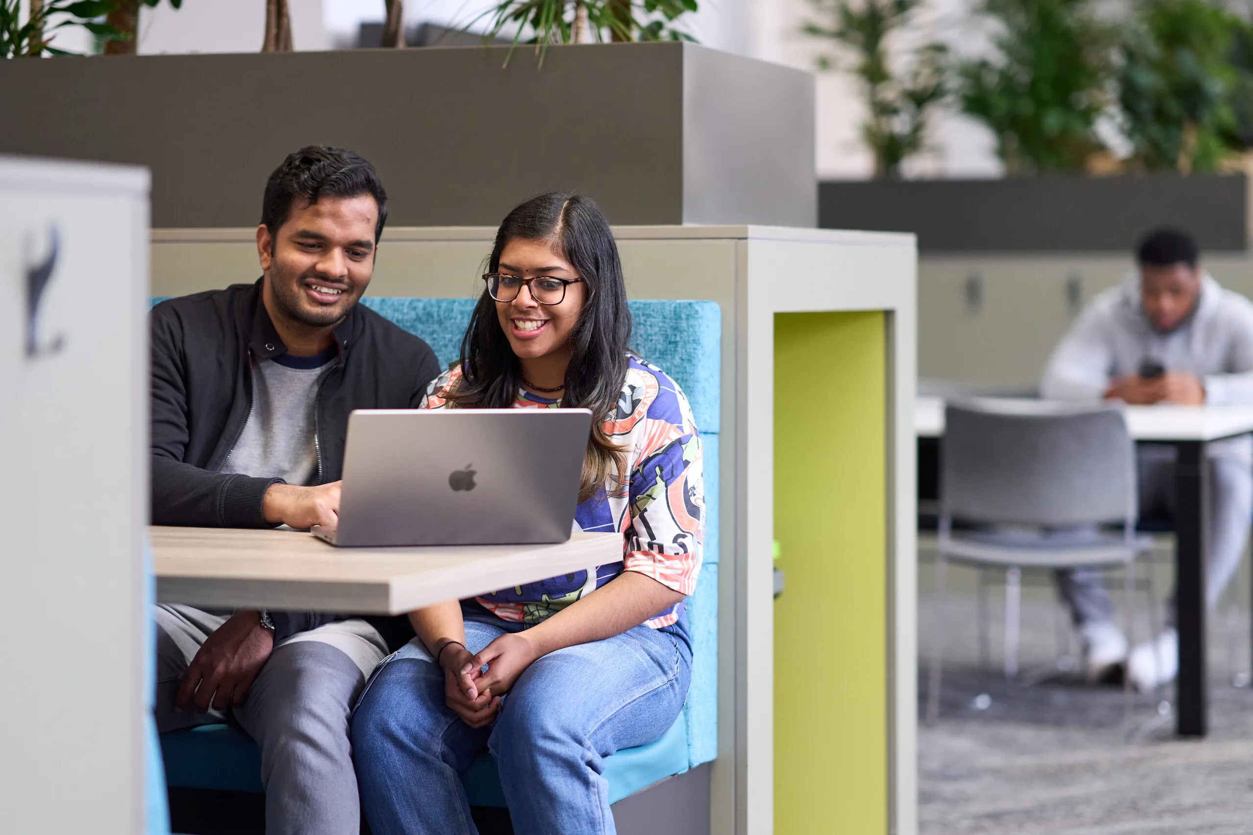 An international student’s experience: Studying a Doctor of Business Administration DBA (Online) with Aston University - two students with a computer in a booth