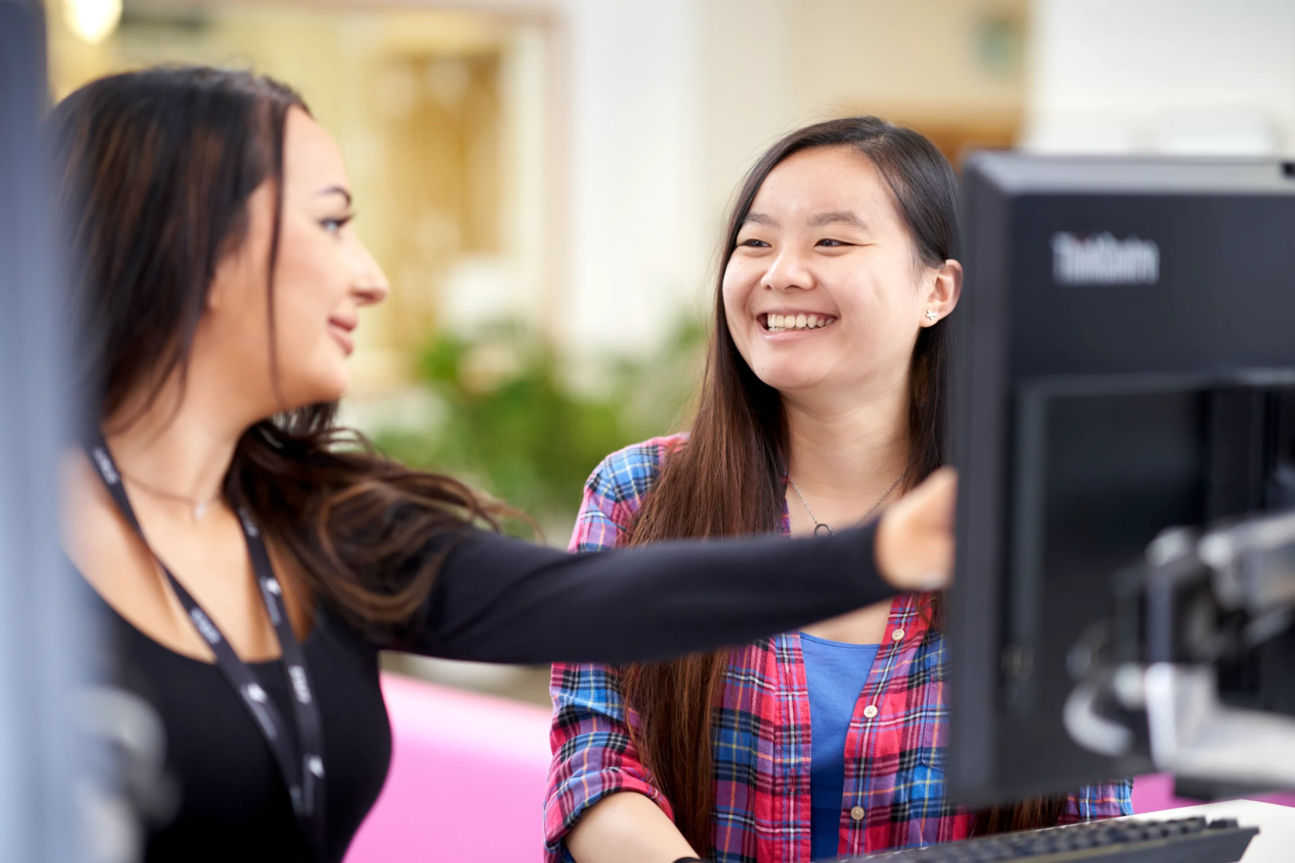 Aston Online: A premier tertiary option for future-focused learning - two smiling women students facing a computer