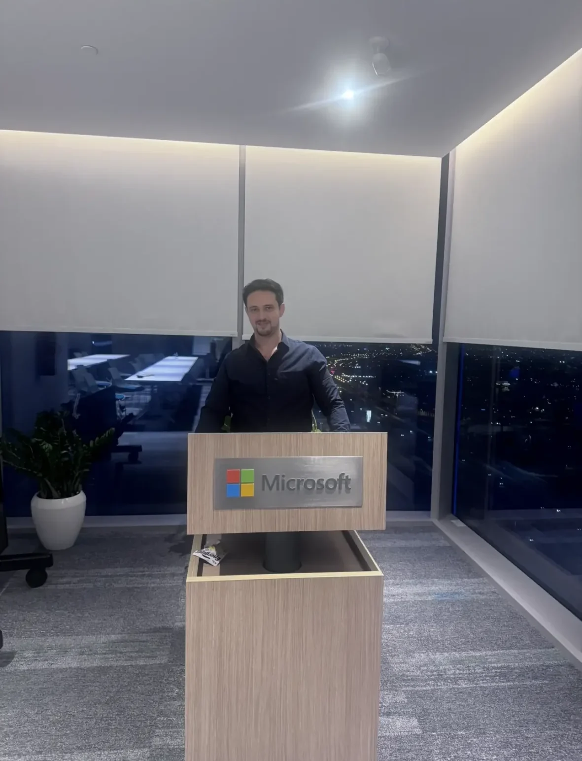 Baker Alamayreh - Aston Online Computer Science MSc student - male standing in front of Microsoft podium