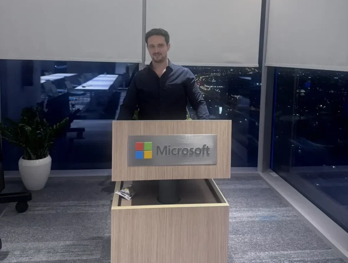 Baker Alamayreh - Aston Online Computer Science MSc student - male standing in front of Microsoft podium