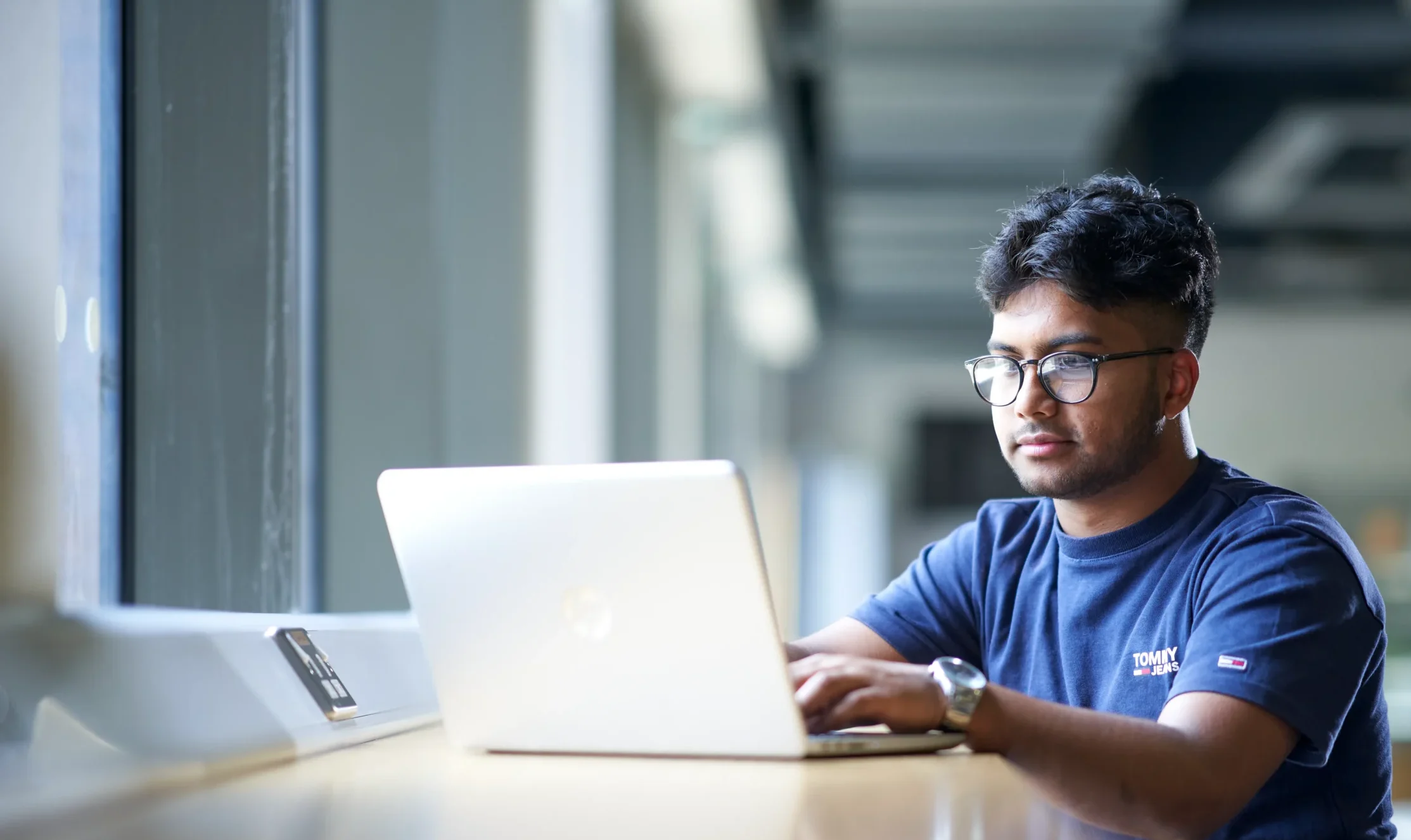 Cybersecurity BSc Aston Online - man sitting in front of laptop