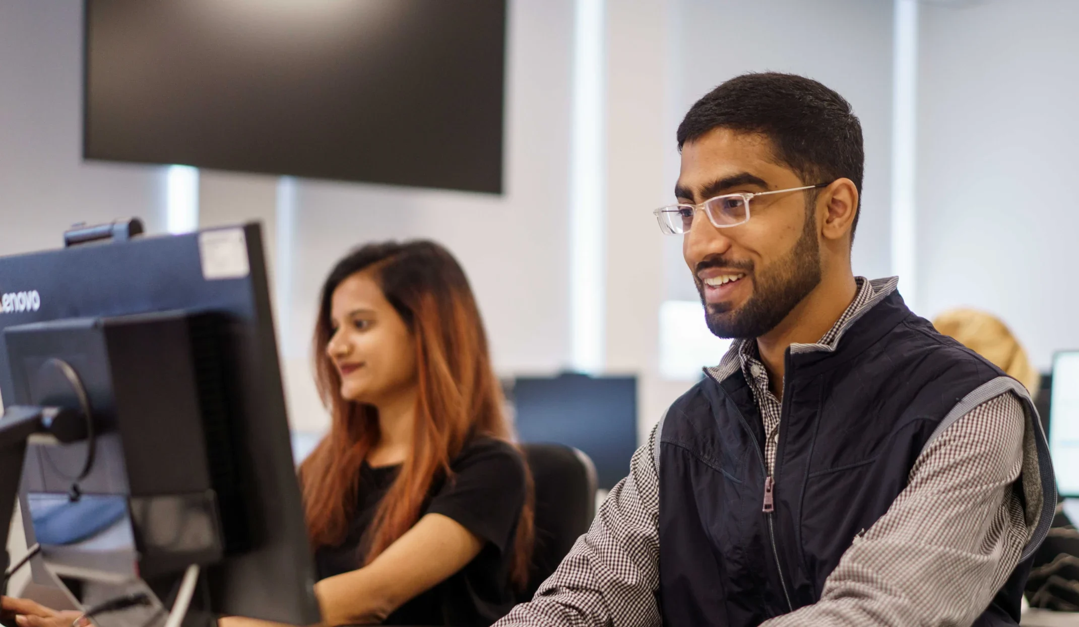 Cybersecurity MSc Aston Online - man smiling while working computer