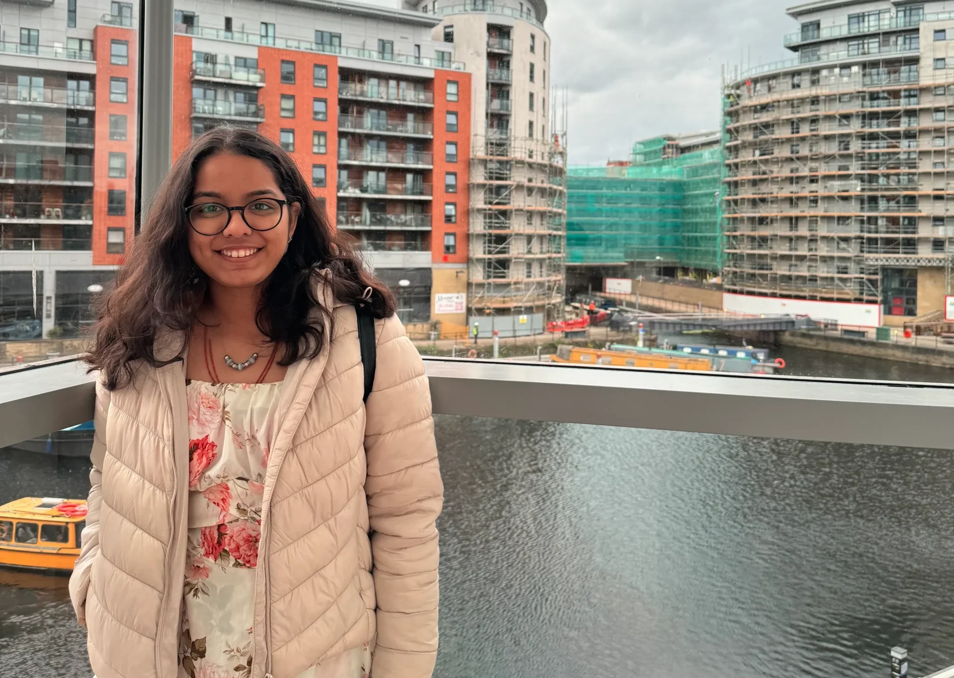 Diya Patel - Aston Online student smiling in front of buildings and river