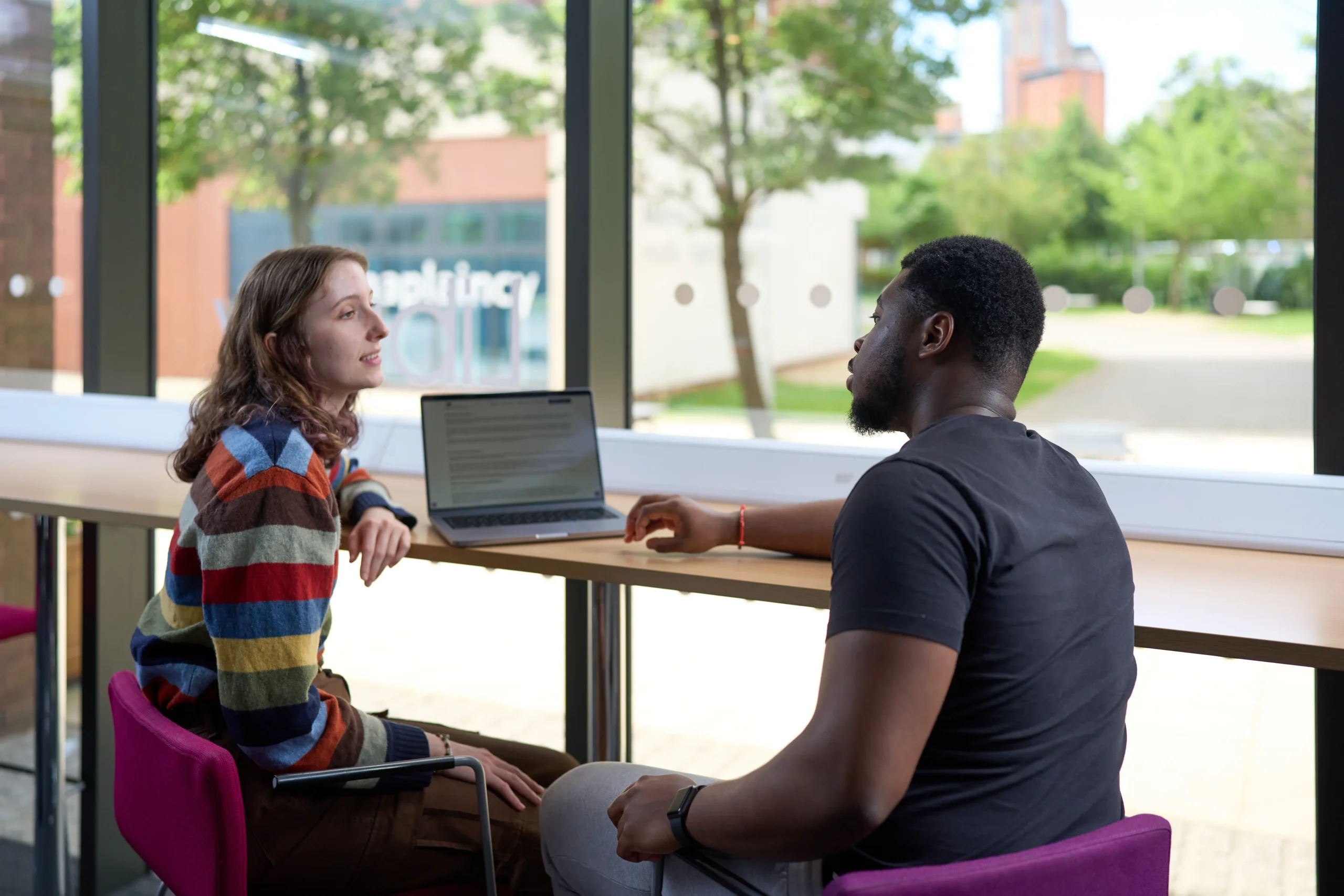 How technology is changing legal careers - man and woman have discussion at counter over shared laptop