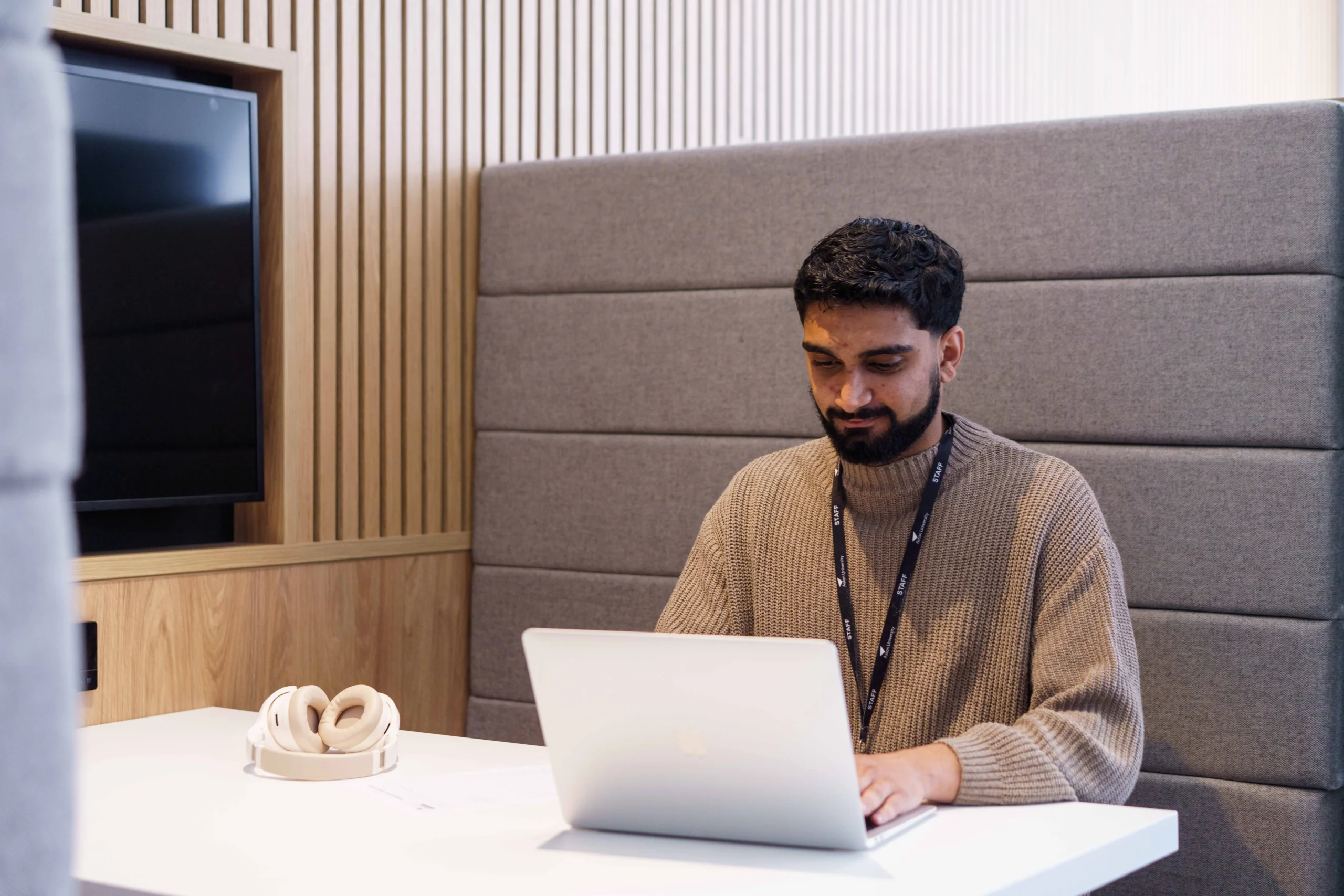 How to become a data scientist - man sitting working on a laptop in a booth