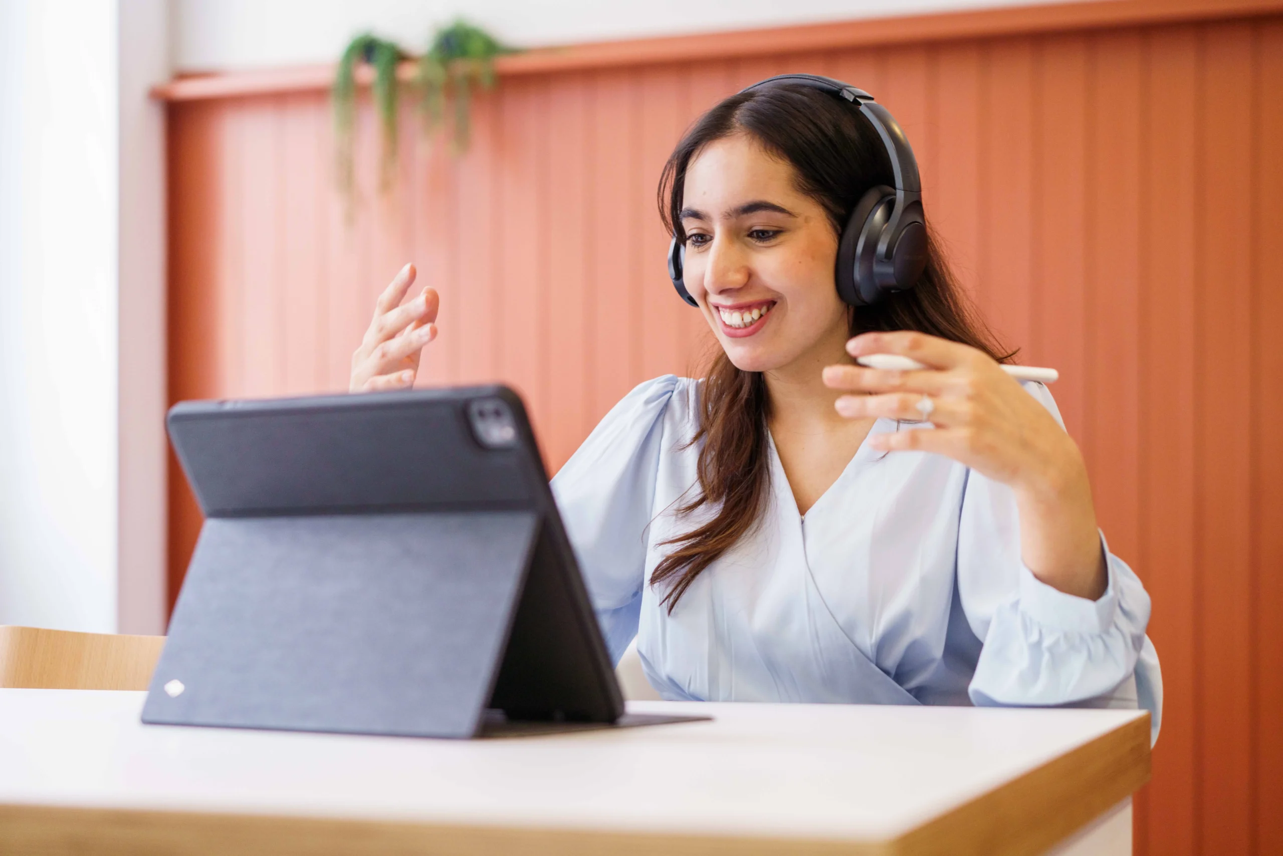 How to become a lawyer with an Aston Online Bachelor of Law LLB (Hons) Degree - woman with headphones smiling at iPad