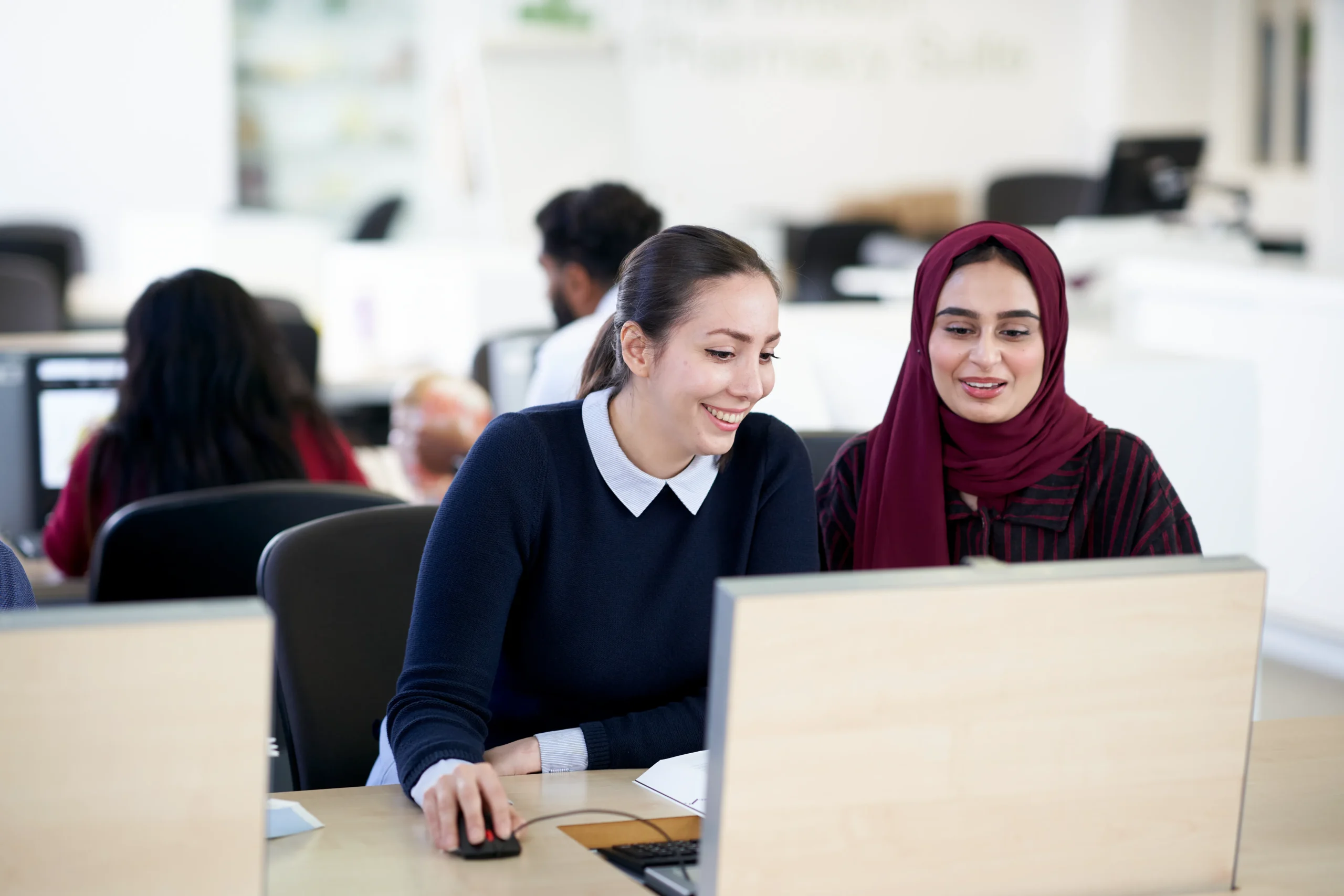 How to become a public health consultant in the UK - two women working together in front of laptop