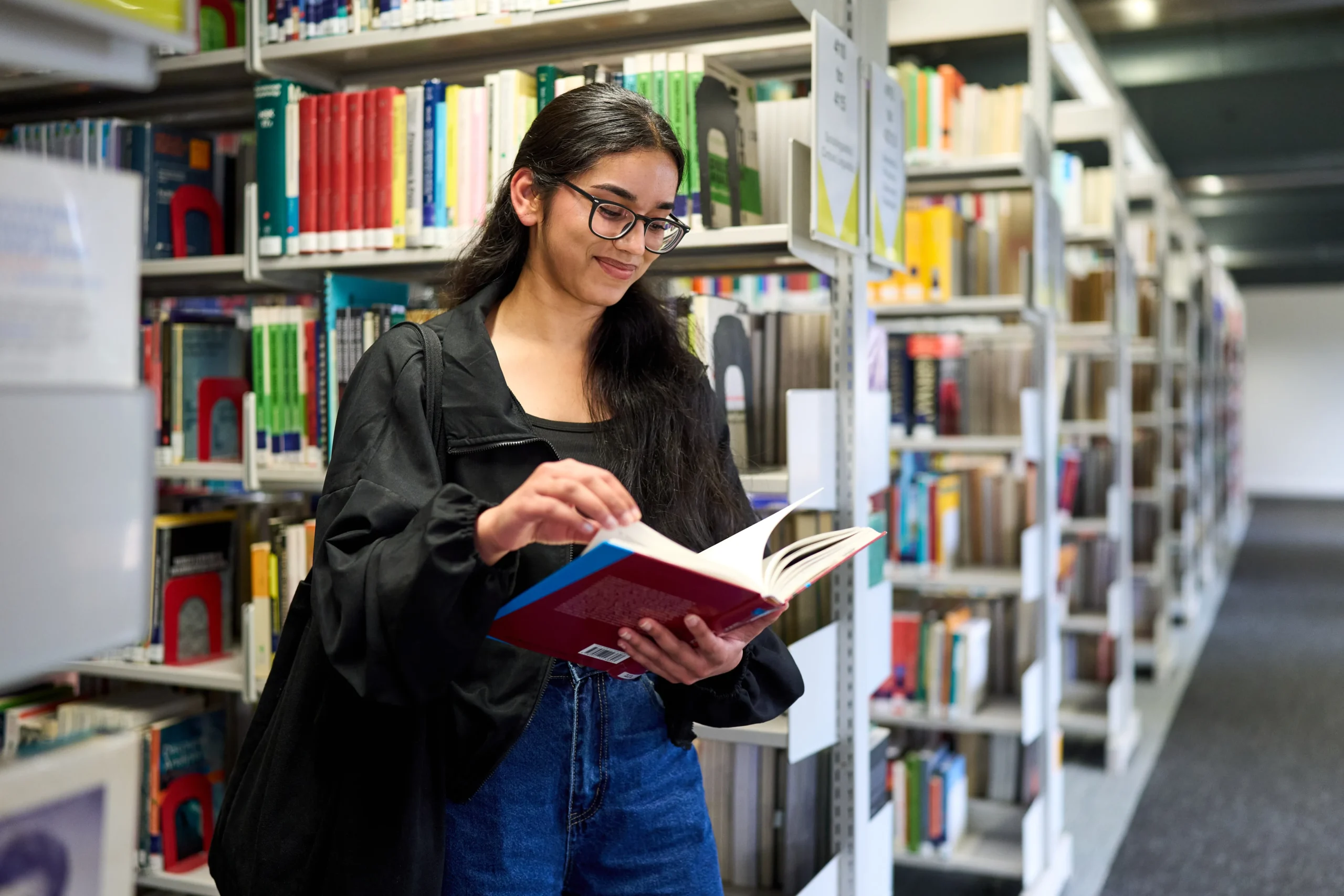 How to personalise your learning journey at Aston Online - woman reading a book in library