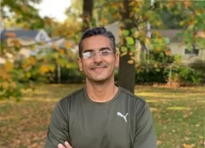 Siddharth Arora - Aston Online DBA student - man smiling, crossed arms.