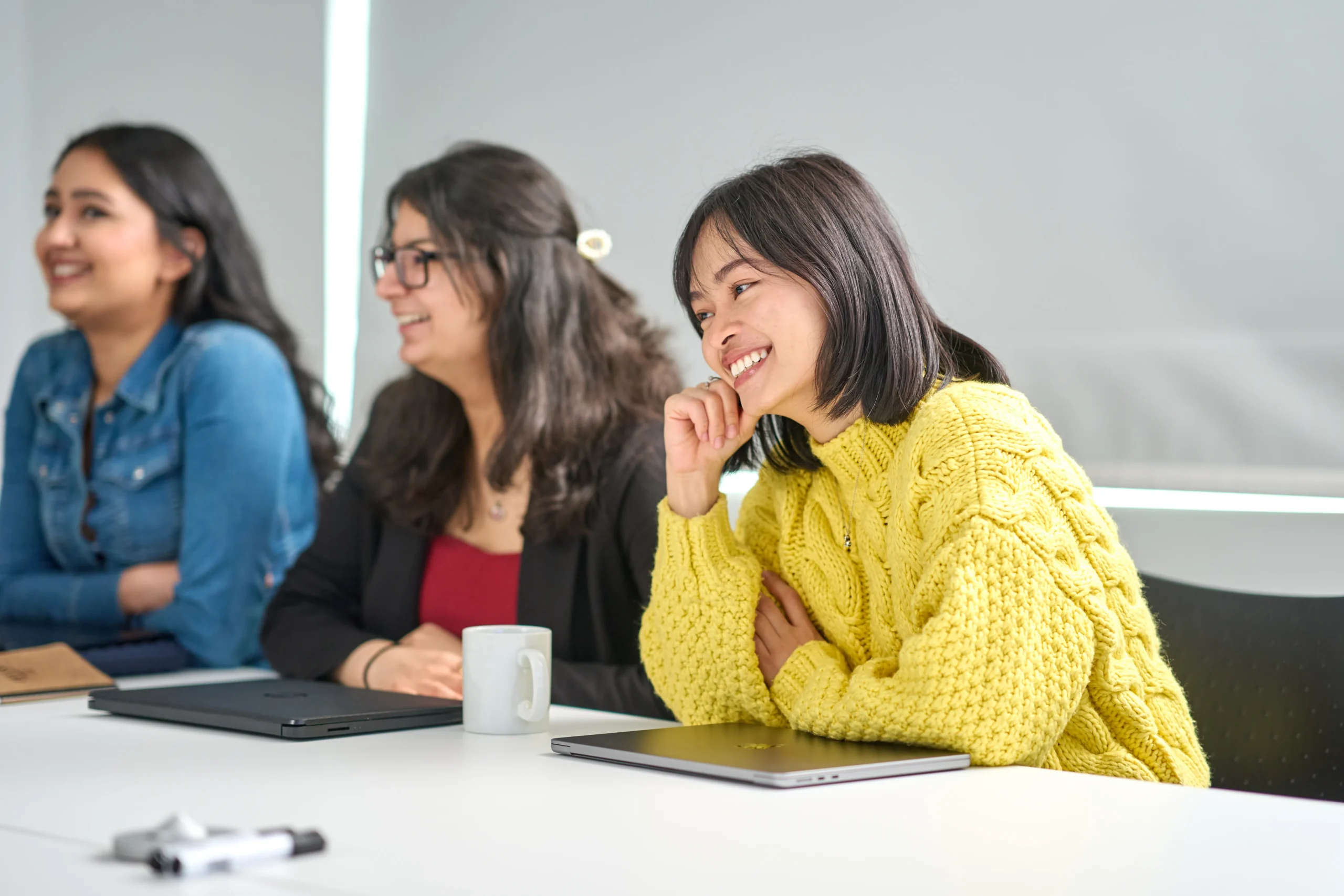 Inside a real-world MSc Business Analytics case study - students around a desk participating in case study