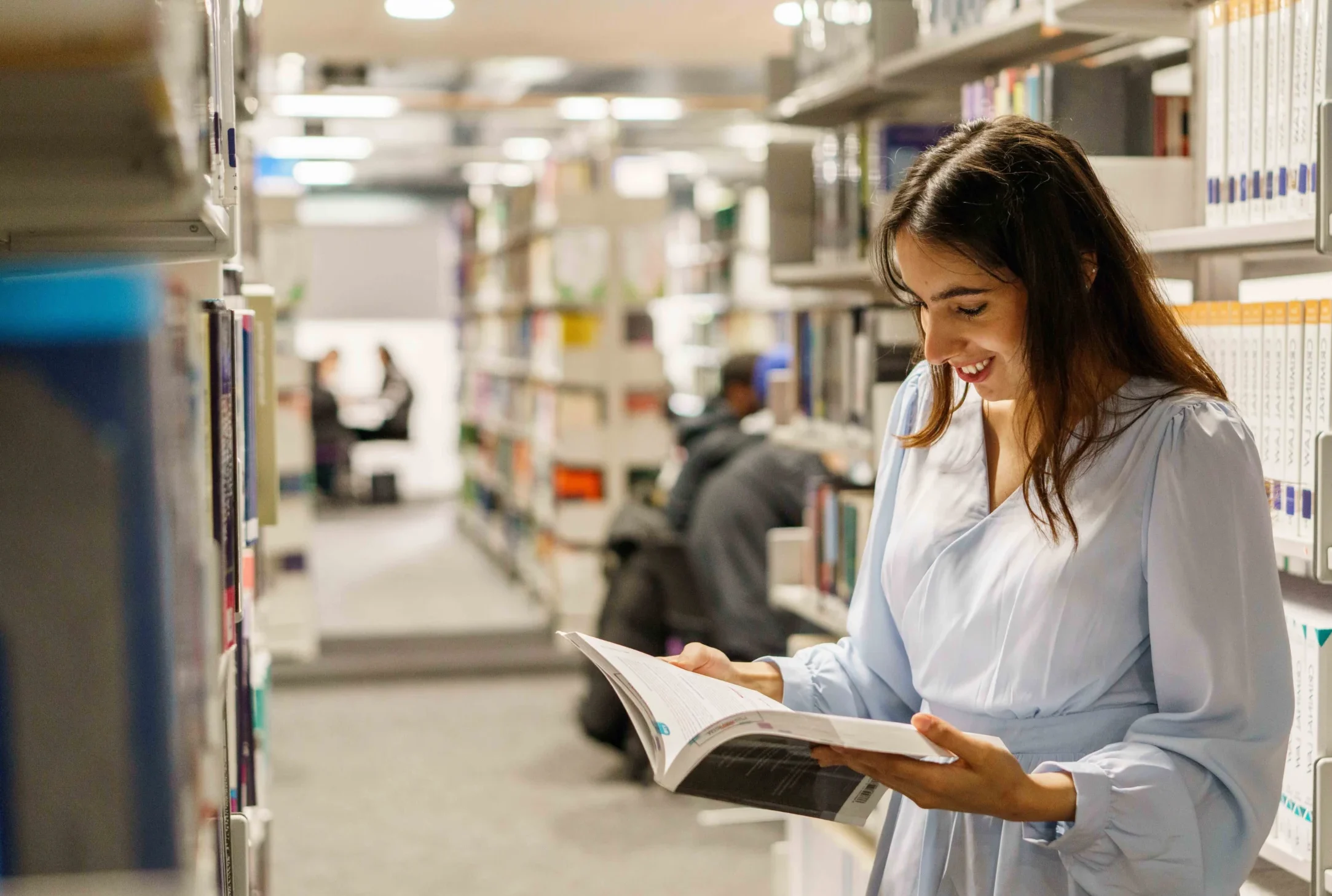 Master of Public Health Aston Online - woman looking at manual in administration centre