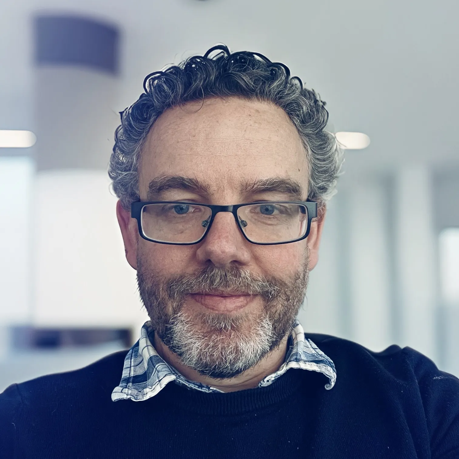 Paul Grace, Cybersecurity BSc Programme Director - wearing glasses and smiling