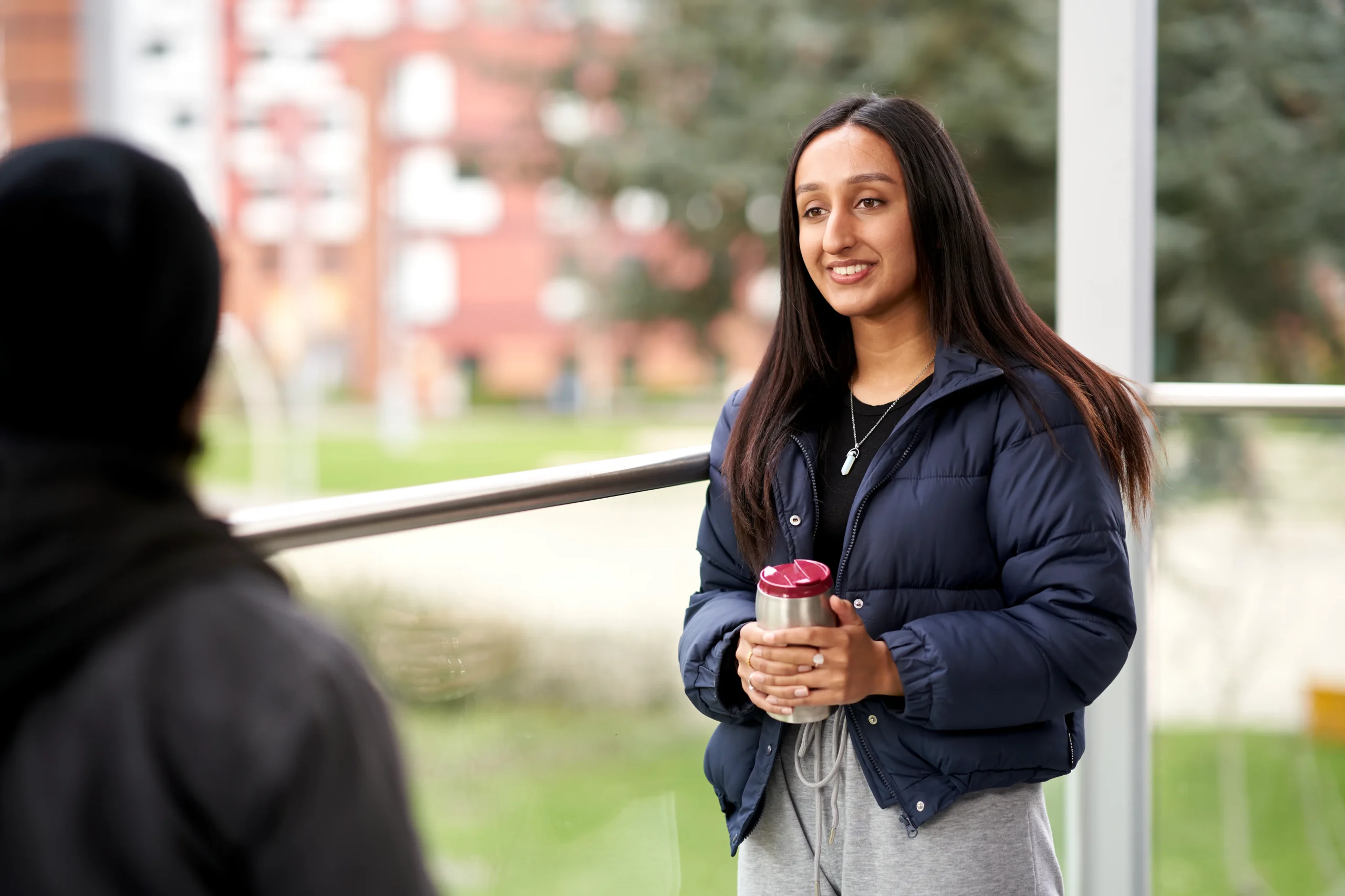 Expert Q&A: Your top questions about studying a Master of Public Health online answered - students in conversation in a hallway