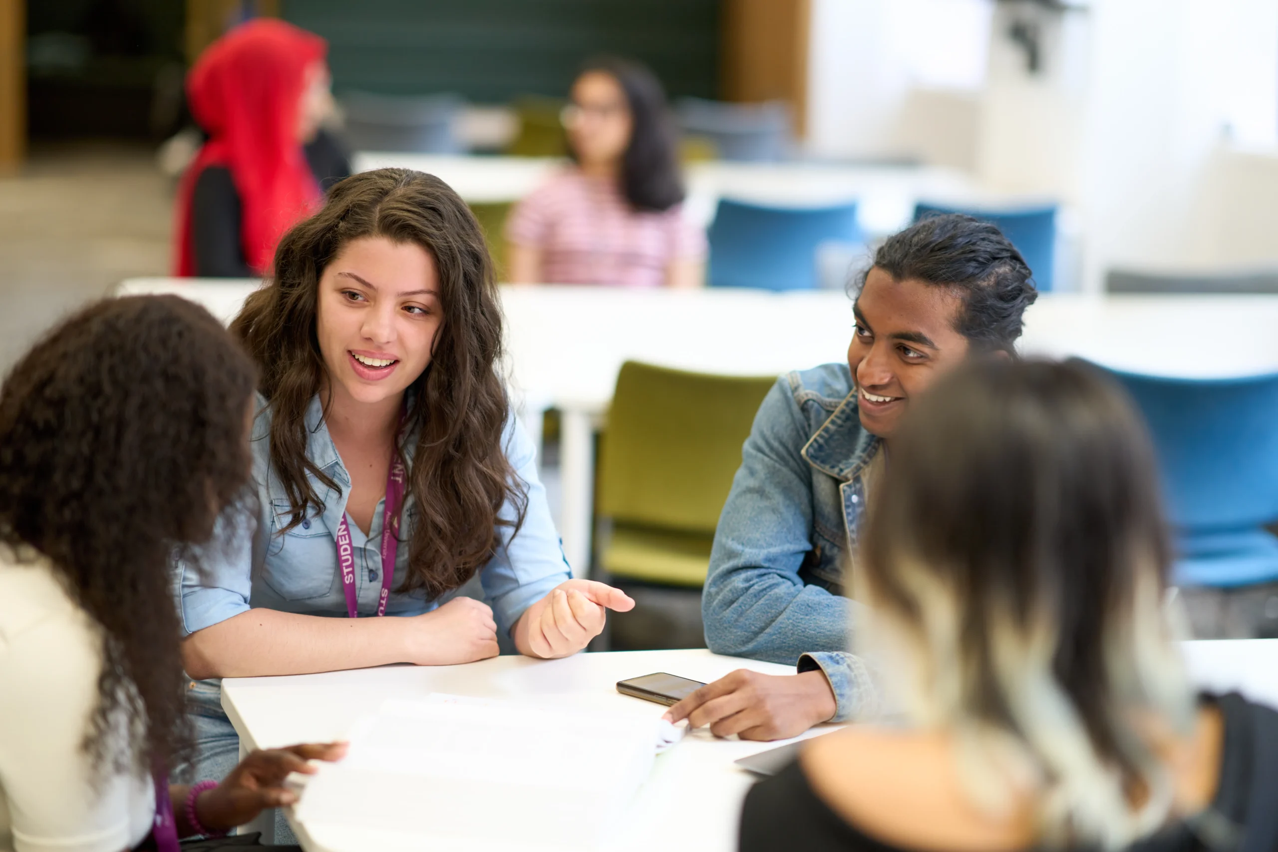 Why studying psychology can strengthen your HR career - four students around a table in a deep discussion