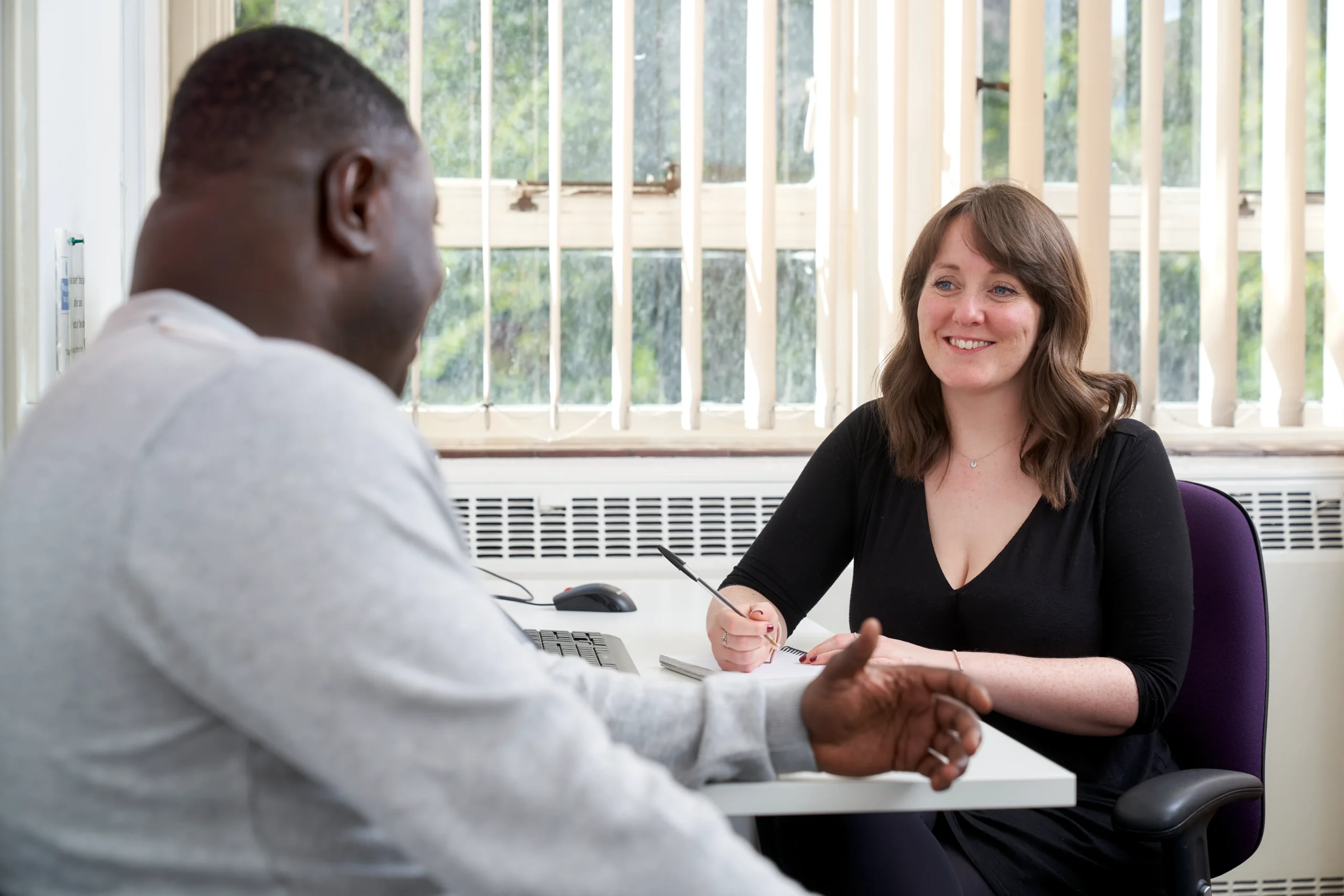 10 careers you can have with a BSc in Psychology - woman taking notes with man in conversation