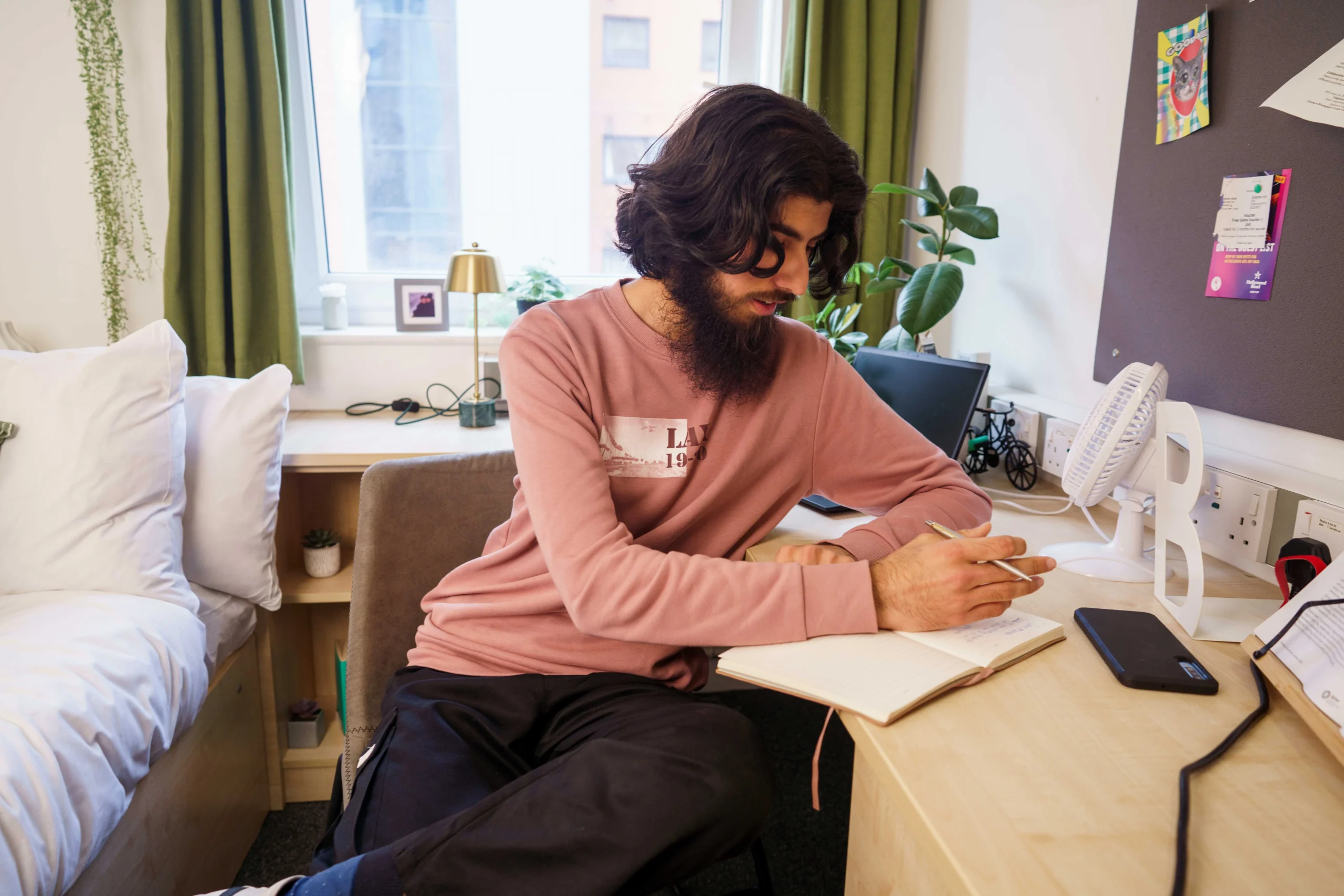 Aston Online blog - Application checklist documents you need and how to prepare them - man sitting at desk with notebook