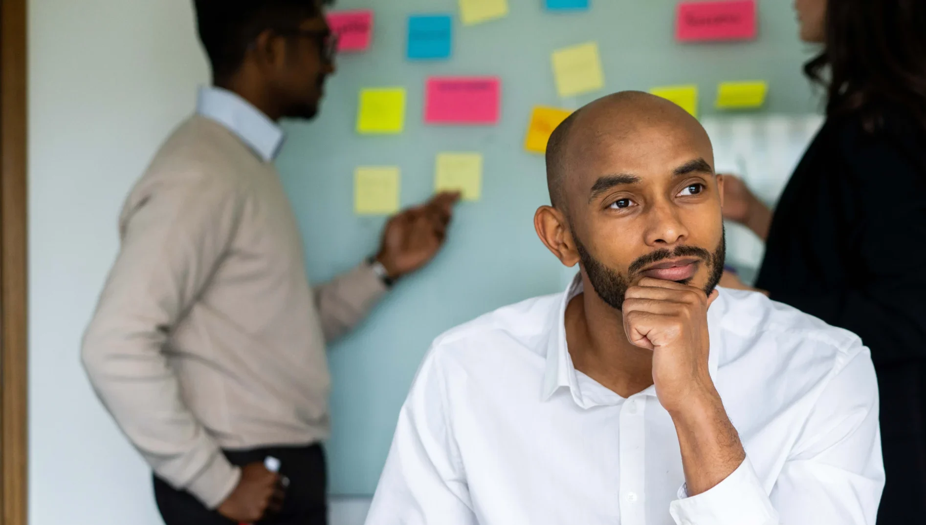 Business Analytics MSc Aston Online - man looking thoughtful during strategic business meeting