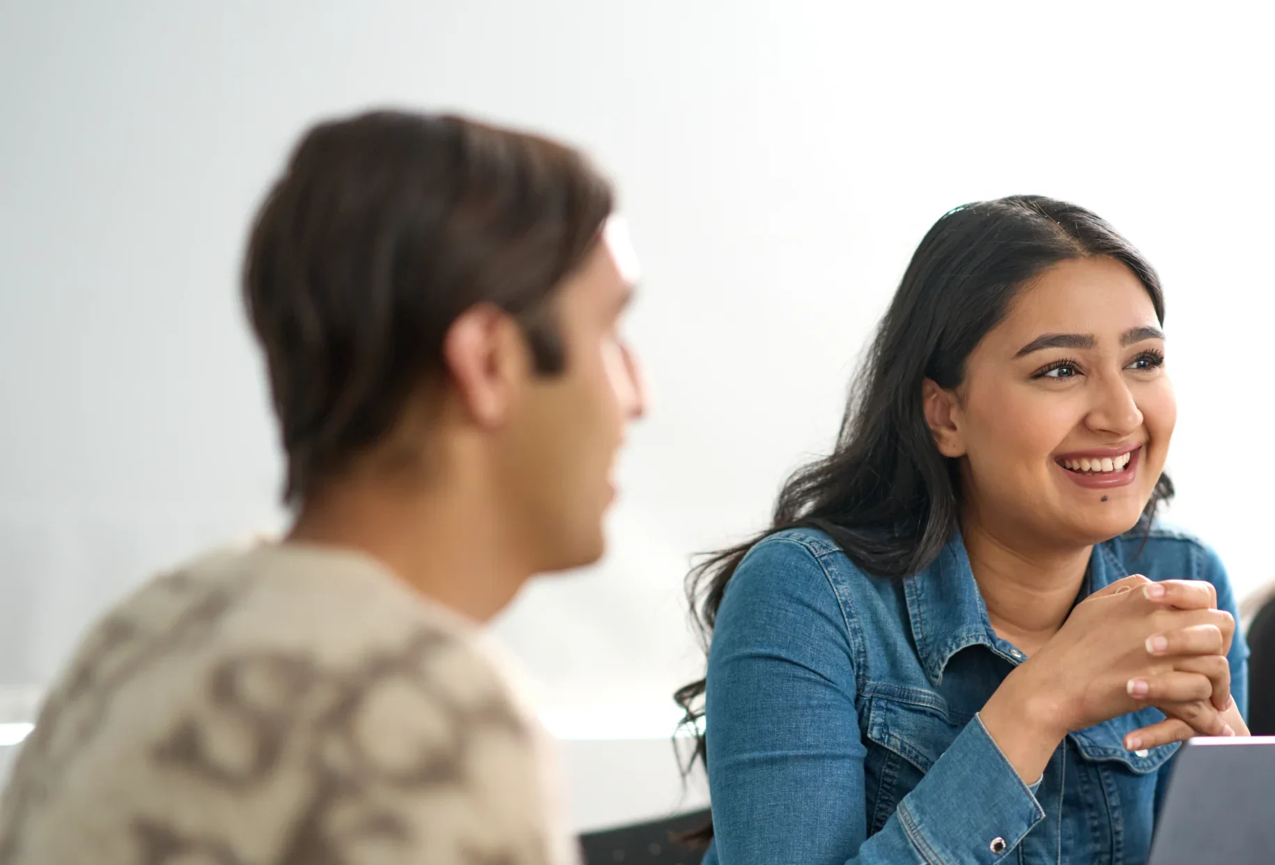 Business and Management BSc Aston Online - woman smiling in business meeting with colleagues