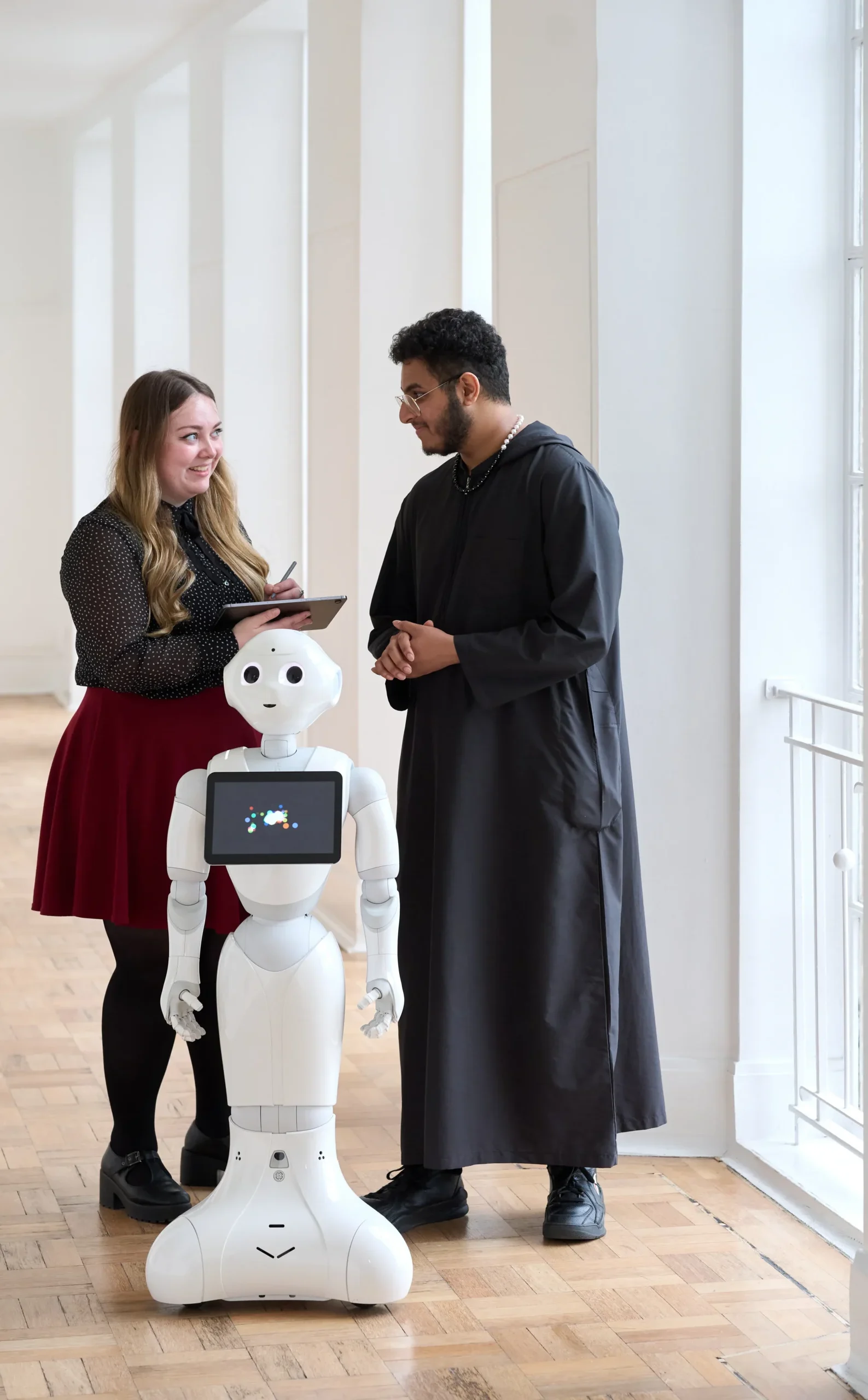 Computer Science MSc Career Prospects- two individuals engaging with tablet in front of robotic humanoid