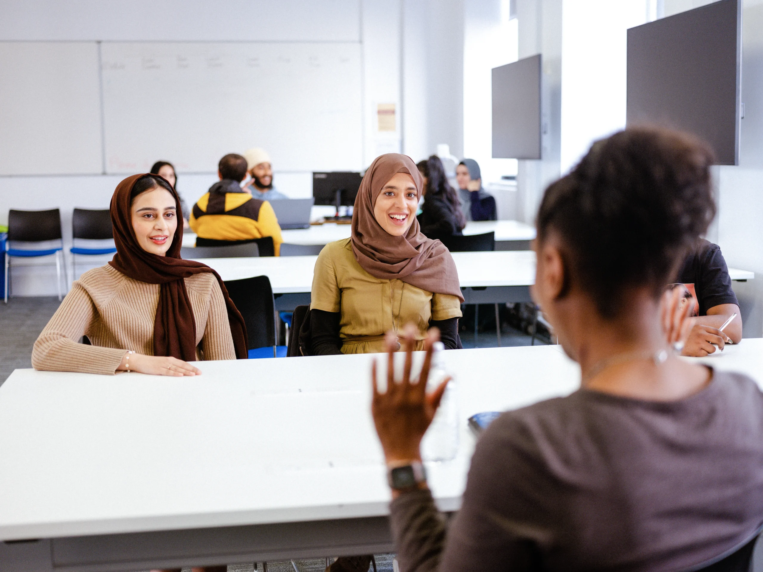 Aston Online Computer Science and Cybersecurity - two women attending a talk