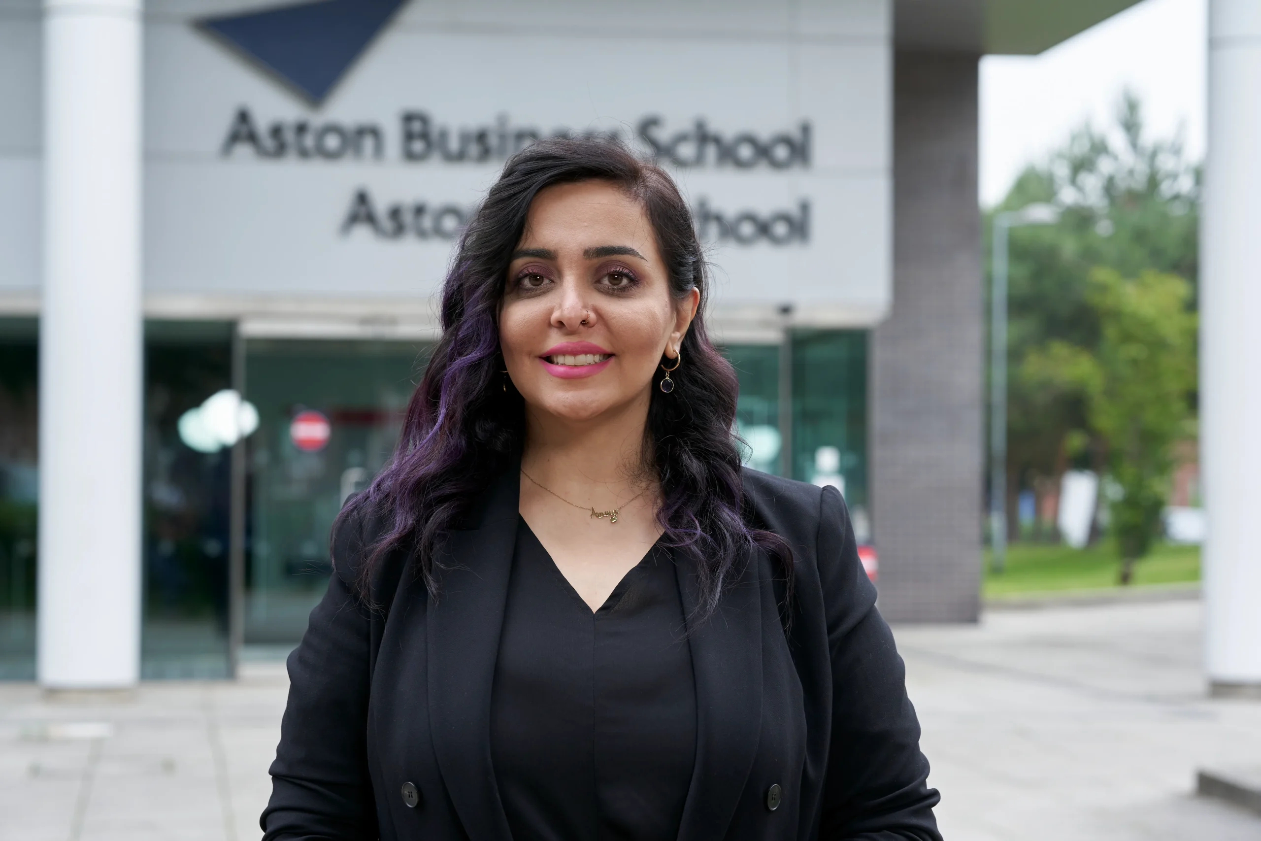 Aston Online MBA - Woman standing in front of the Aston Business School building