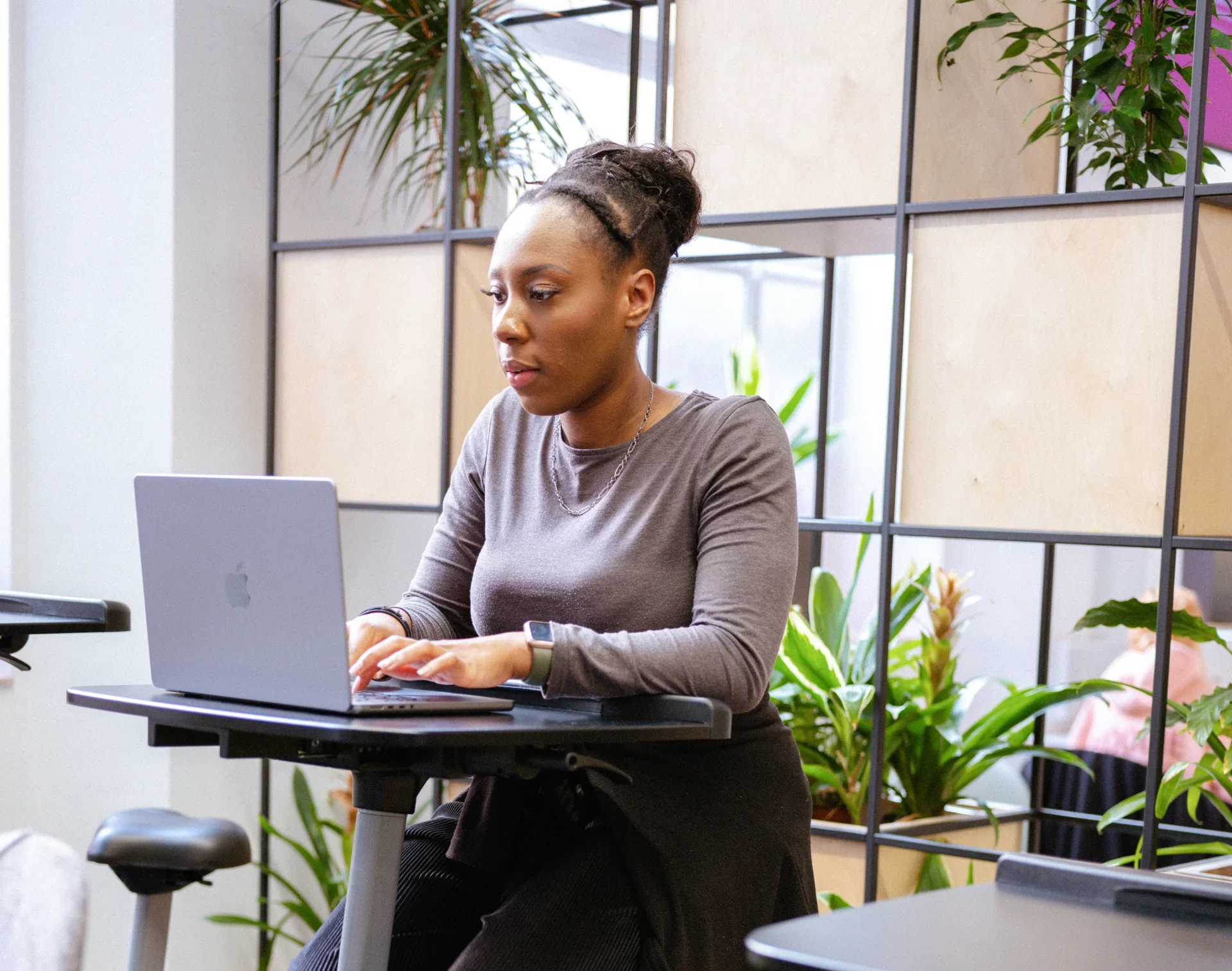 Gather your documentation for submission - woman works on laptop with a serious demeanor