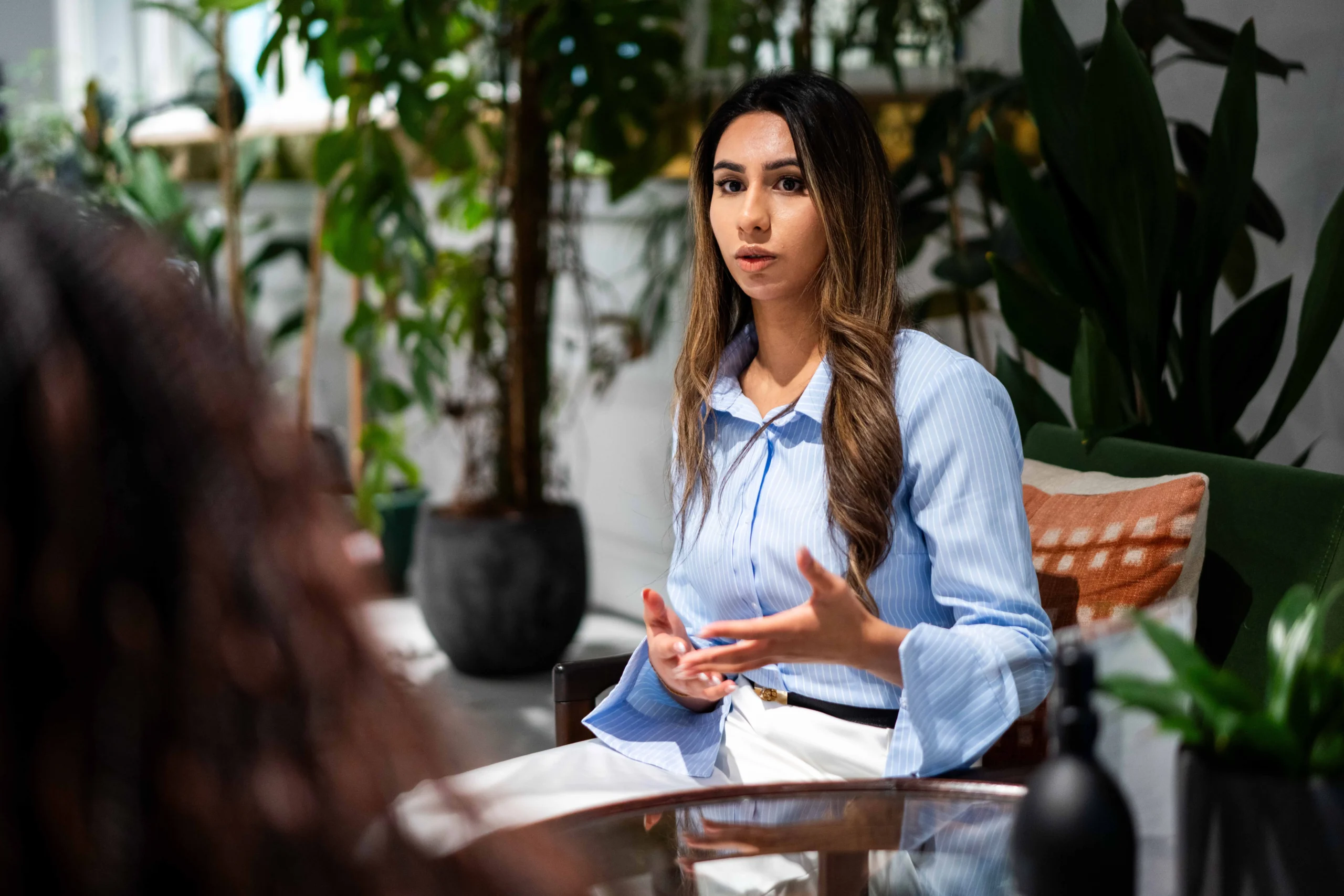 How an Executive Doctor of Business Administration (DBA) can help you deliver real-world change - long-haired women in conversation in leafy office space