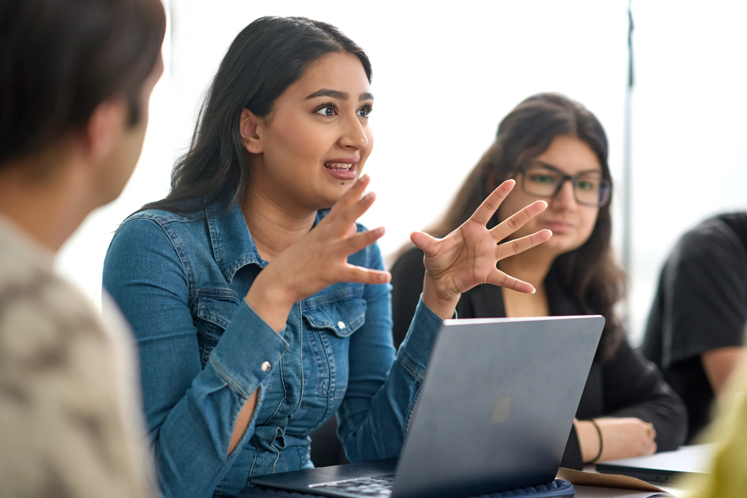 How an Executive Doctor of Business Administration (DBA) can help you deliver real-world change - woman presenting with both hands up in front of tablet