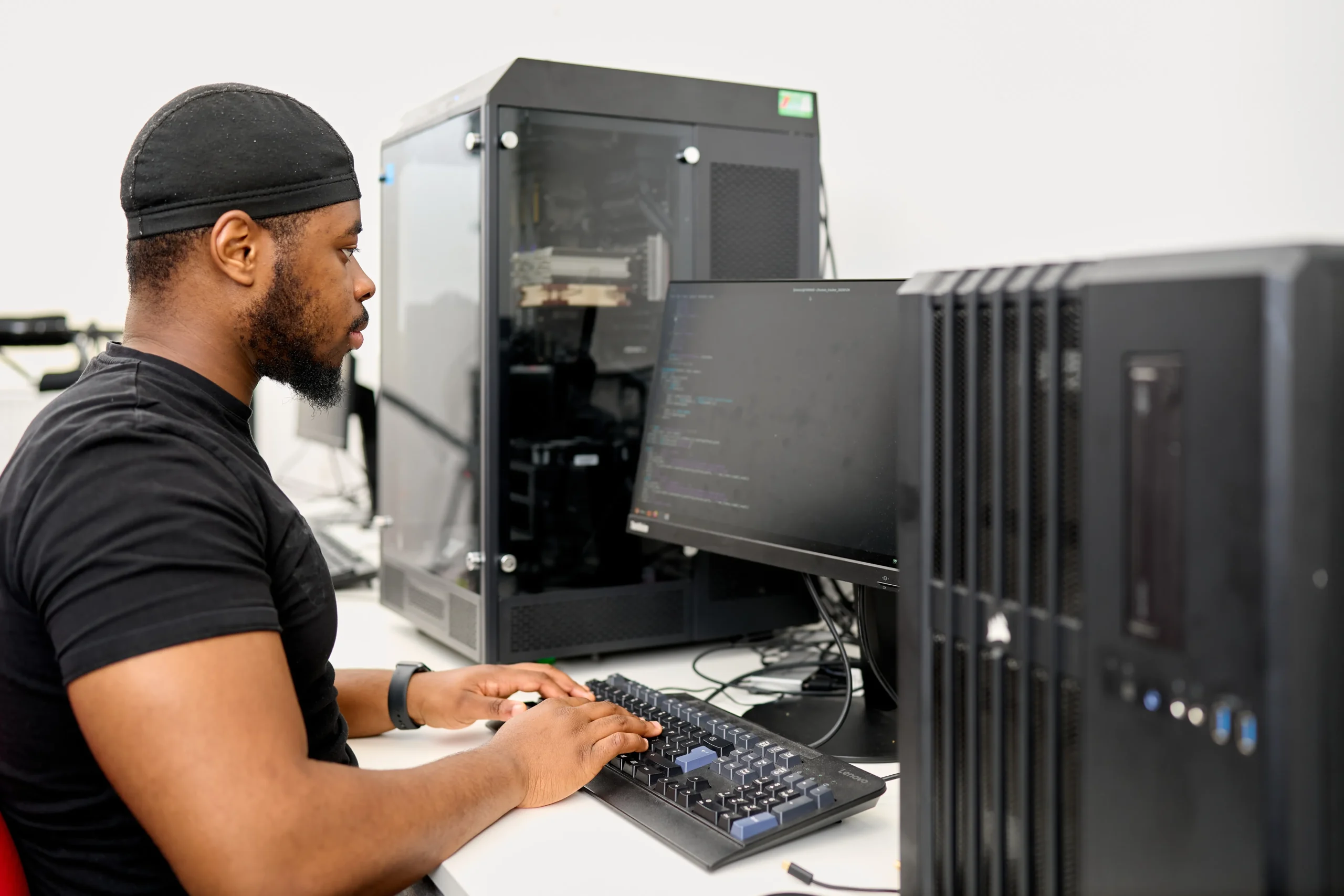 How do computer science graduates perform in the UK job market? Young man working at hi-tech black computer