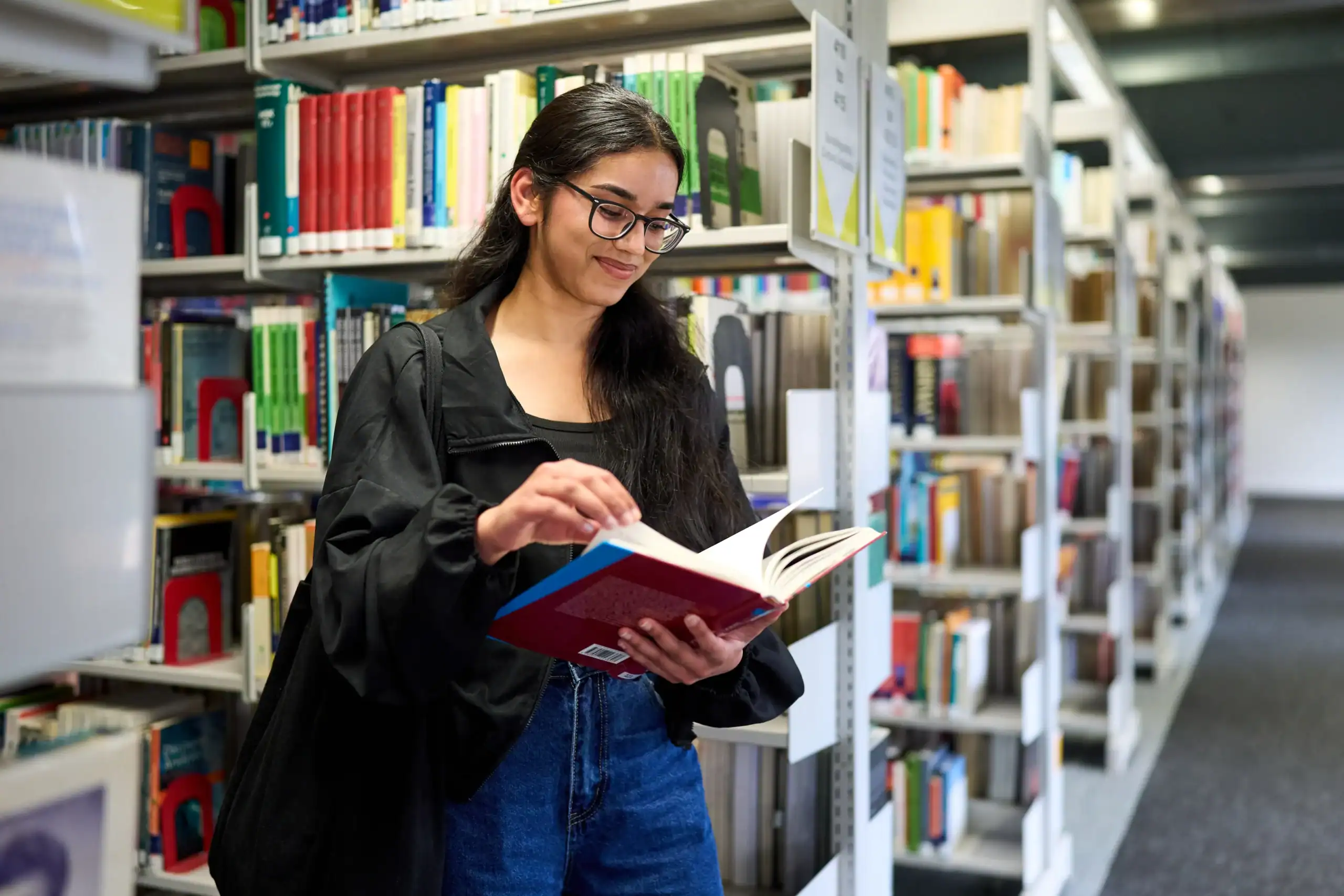 How to personalise your learning journey at Aston Online - woman reading a book in library