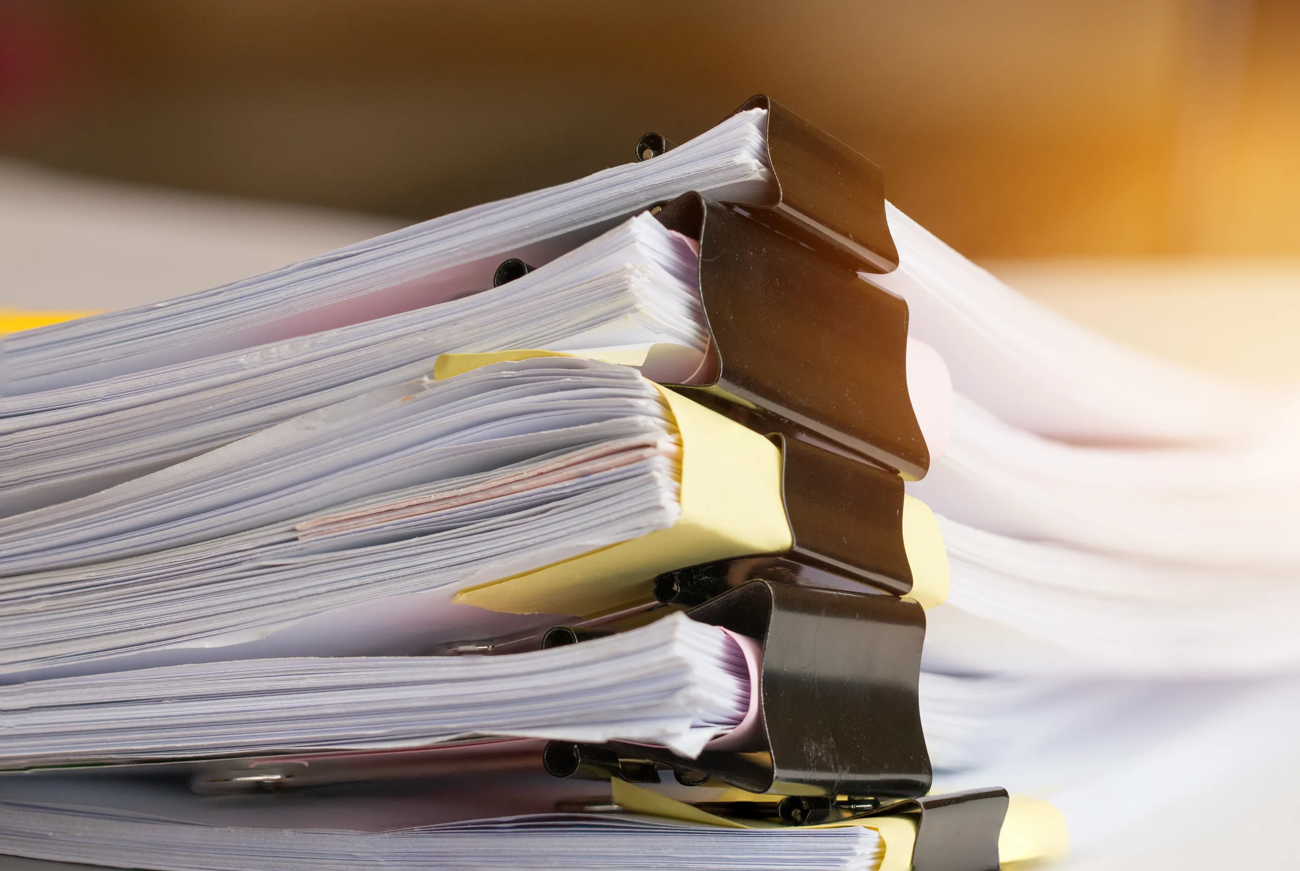 How to write a great DBA research proposal - stack of research manuscripts