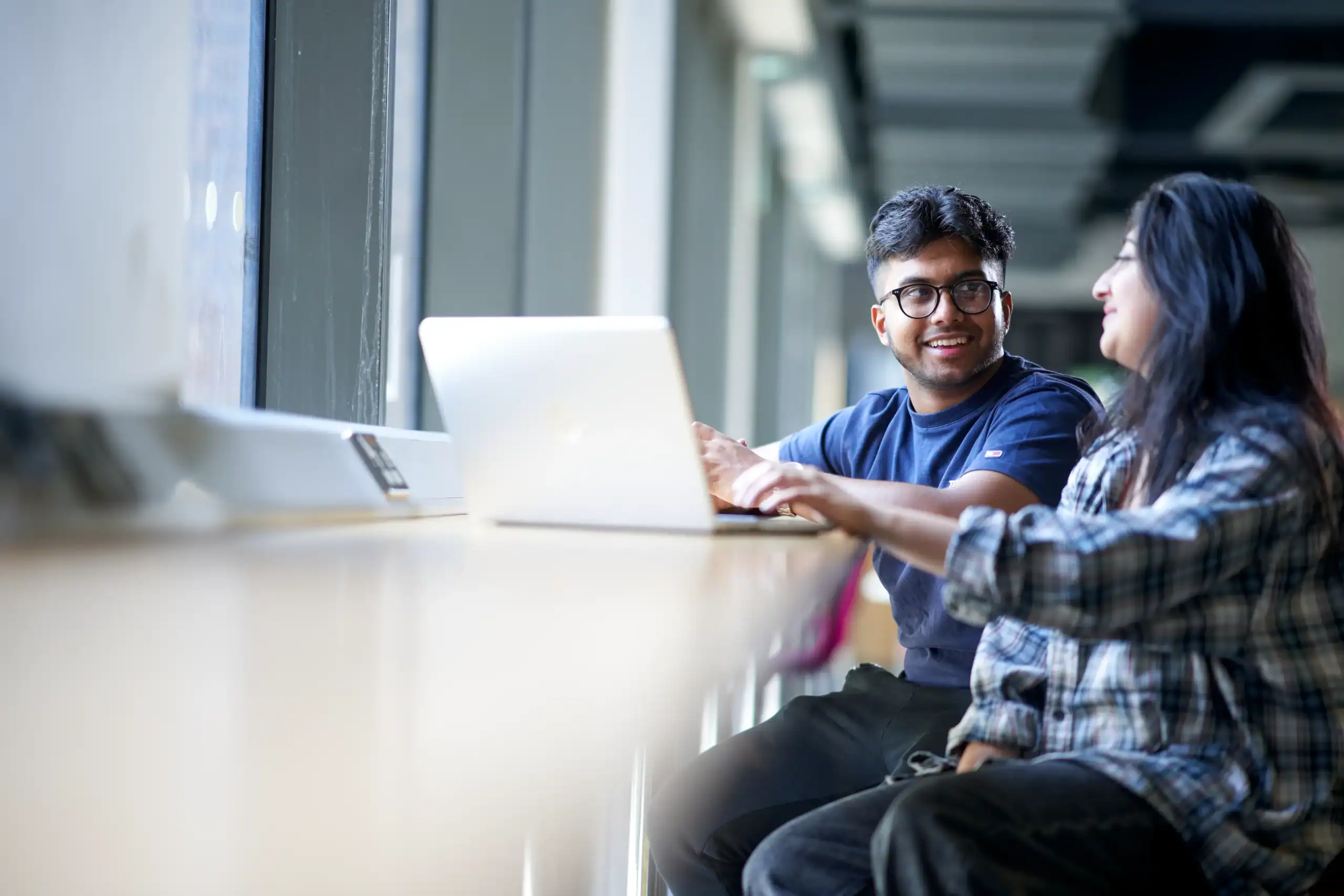 Is cybersecurity the right career path for you? A comprehensive guide - man and woman working together at a counter desk