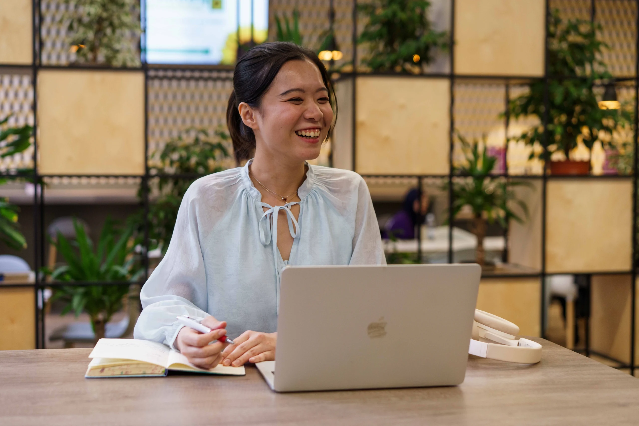 woman smiling, working on laptop