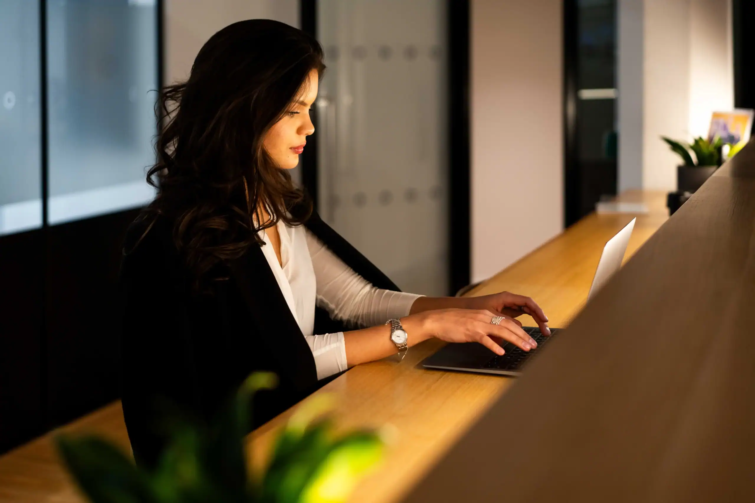 Online learning platform - woman works on laptop with serious demeanor