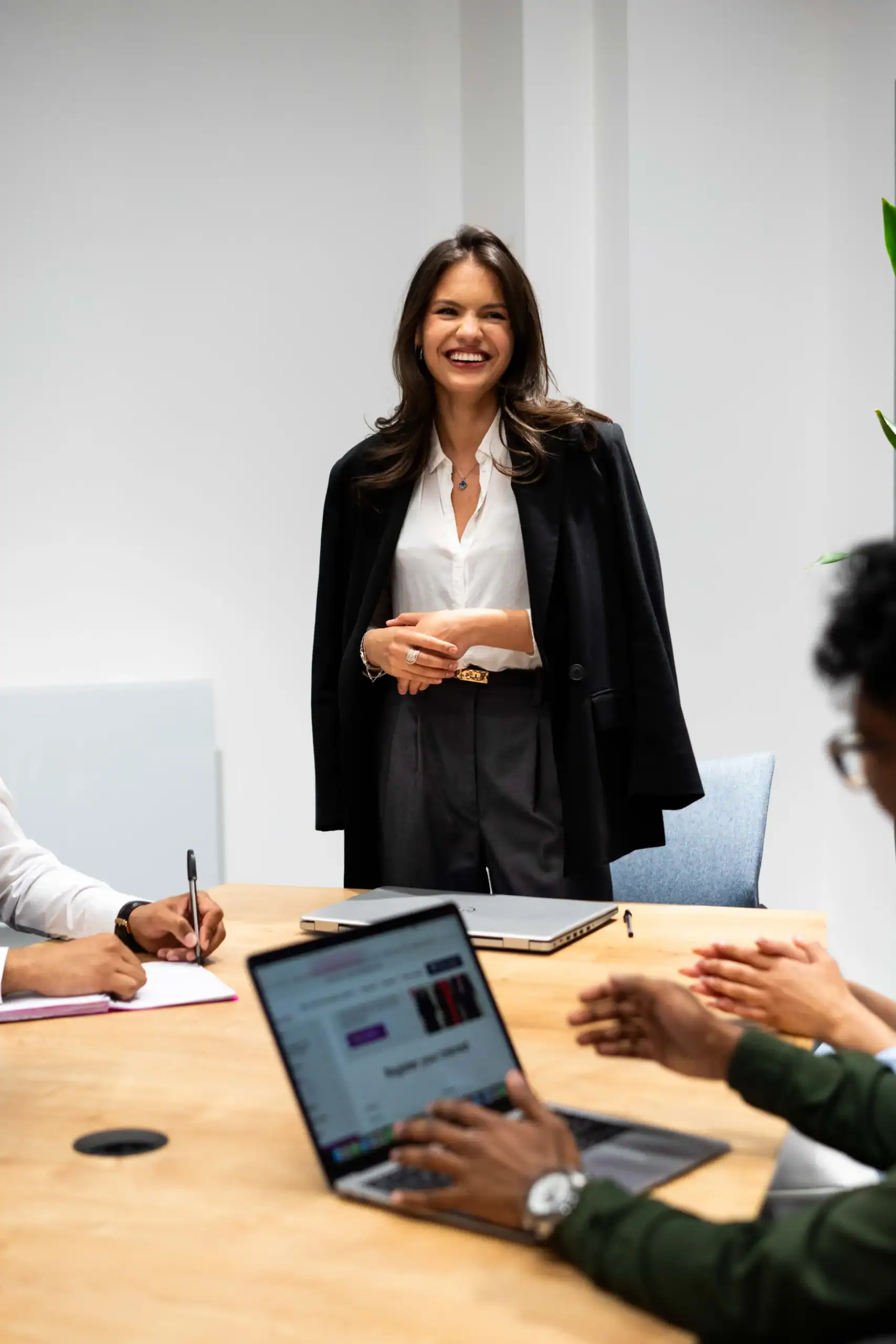 Aston Online - Tailor your MBA to reflect your goals - woman in formal attire standing, smiling