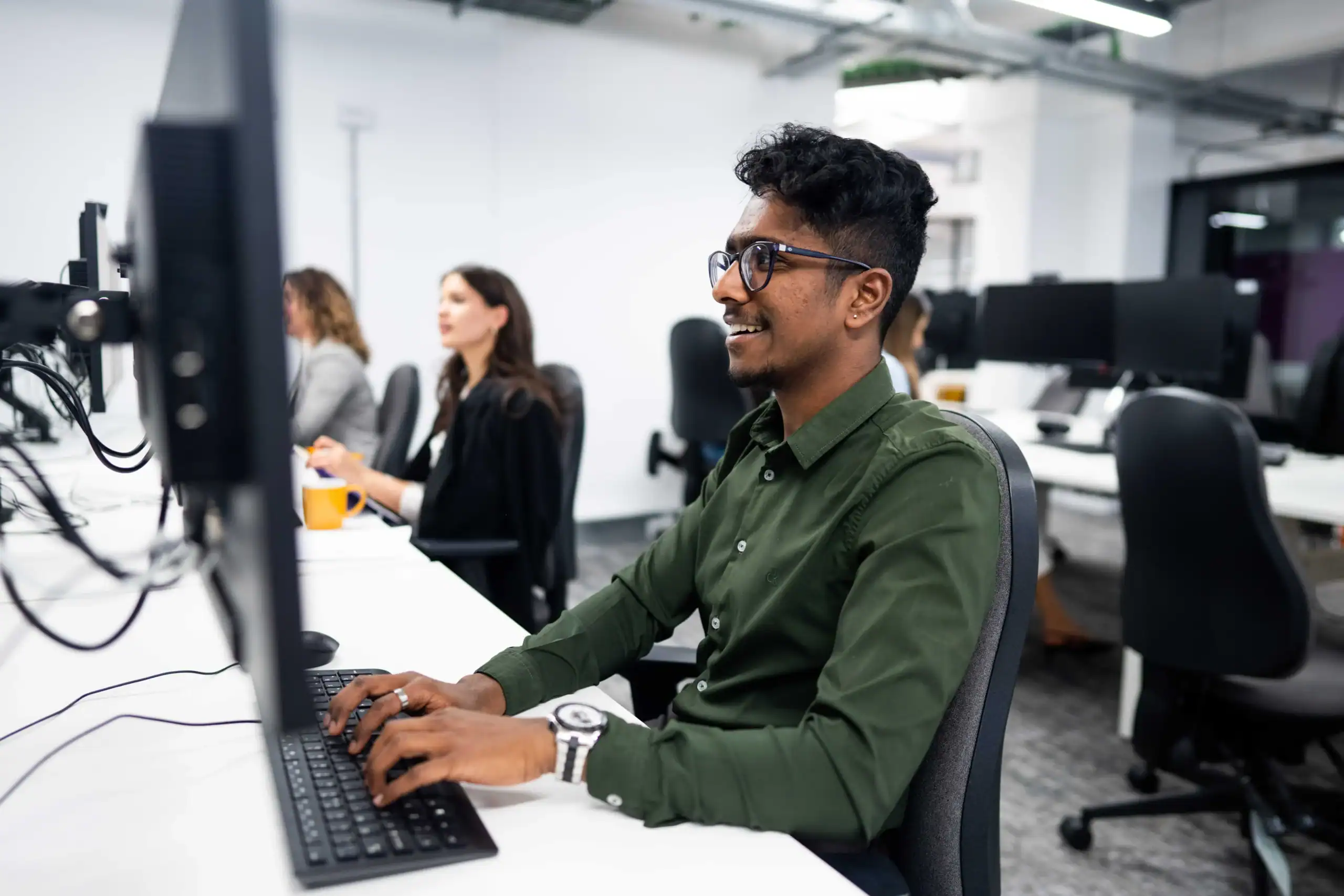 Preparing for a career in Business Analytics - man with glasses working on computer in computer lab
