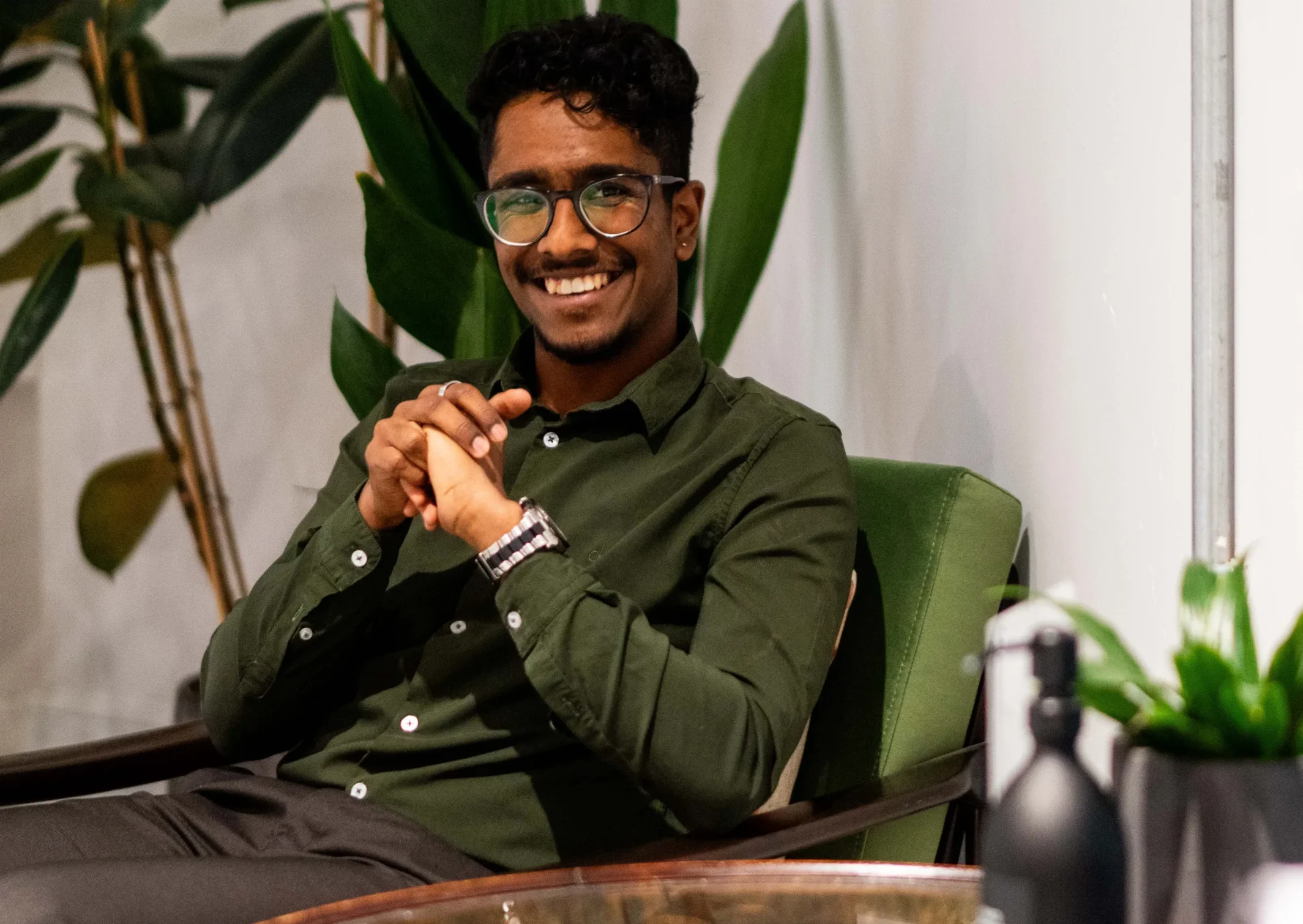 Receive your Aston Online programme offer - man sits in chair smiling broadly with excitement