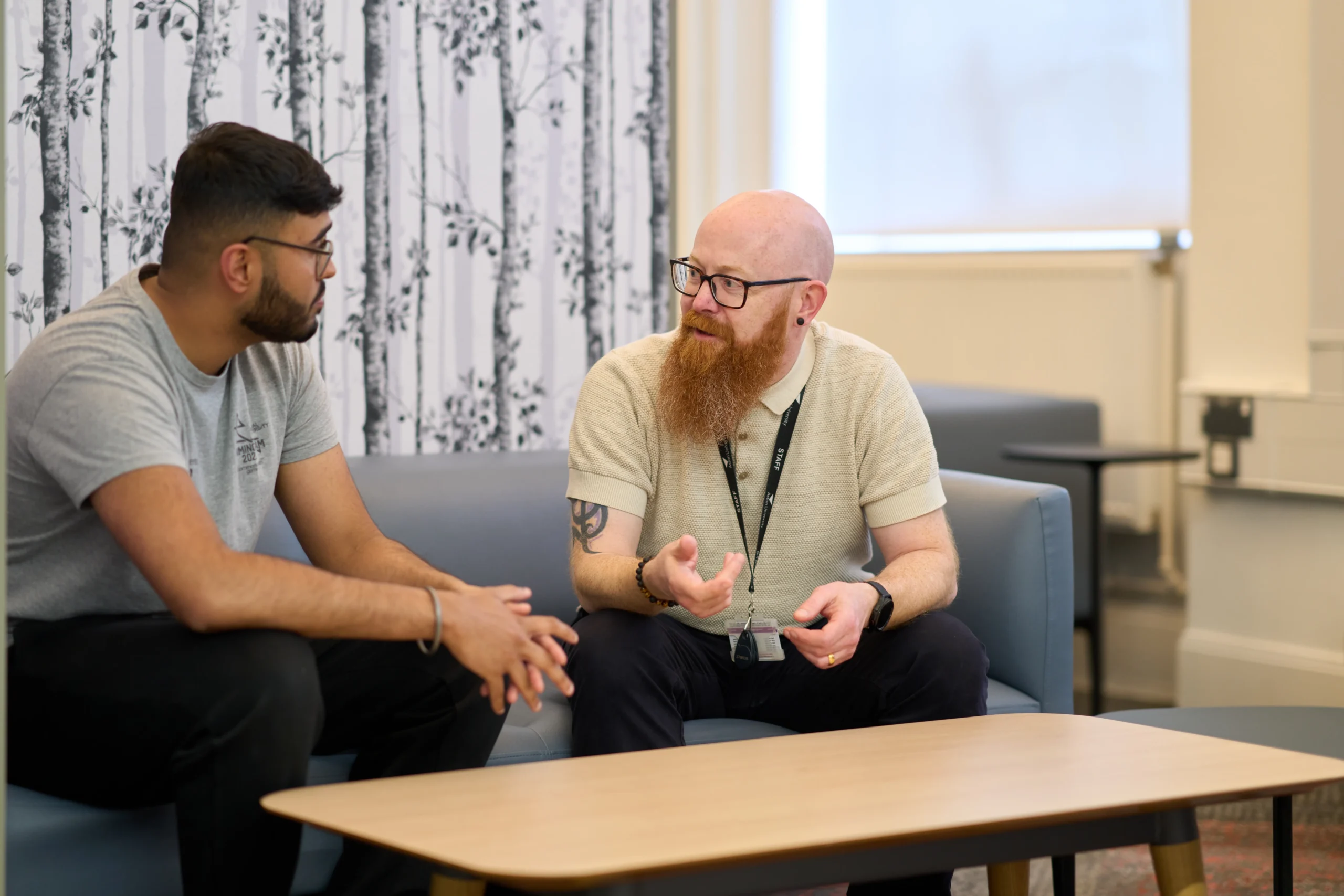 The 101 guide to becoming a psychologist - two men having an animated conversation on a couch.