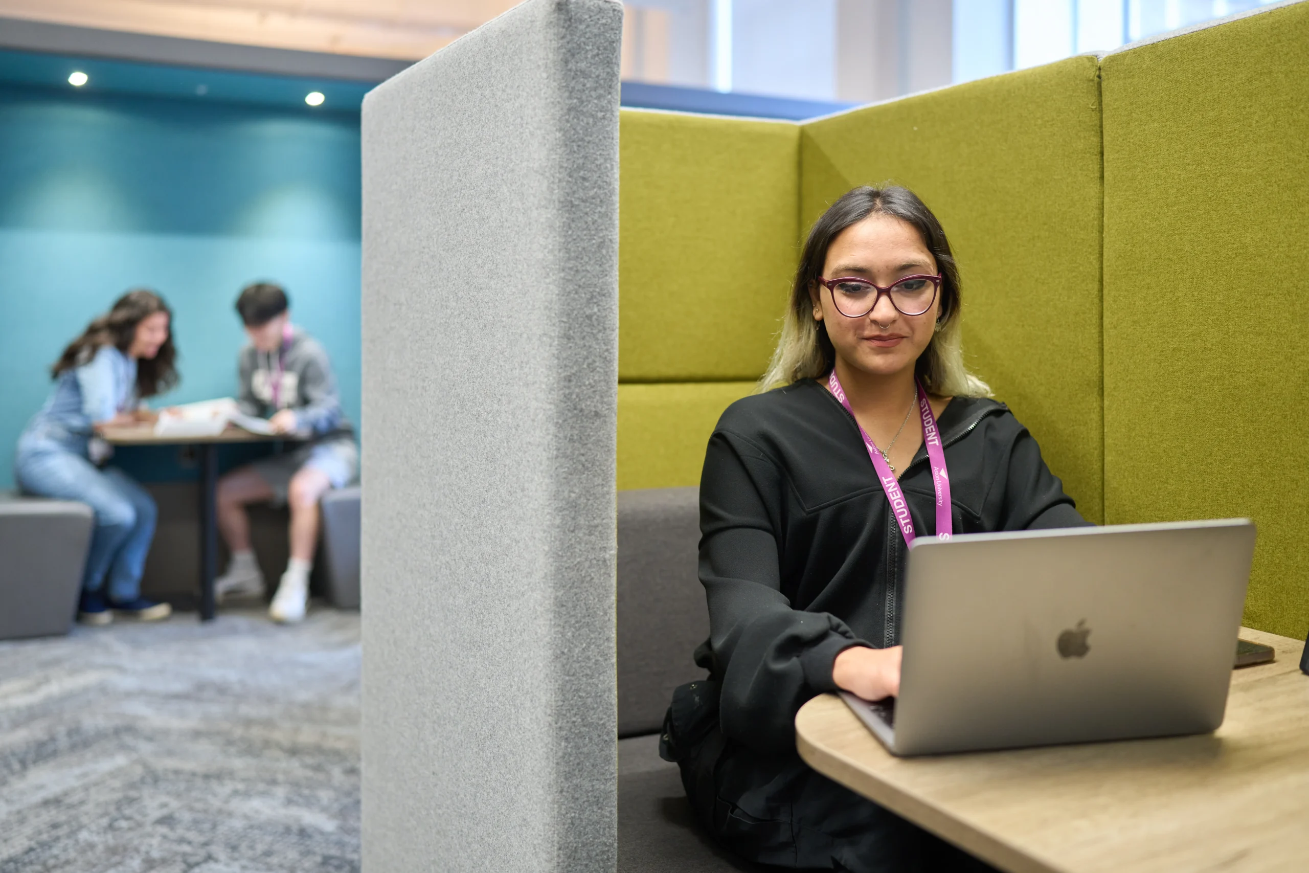 Woman in office pod at laptop