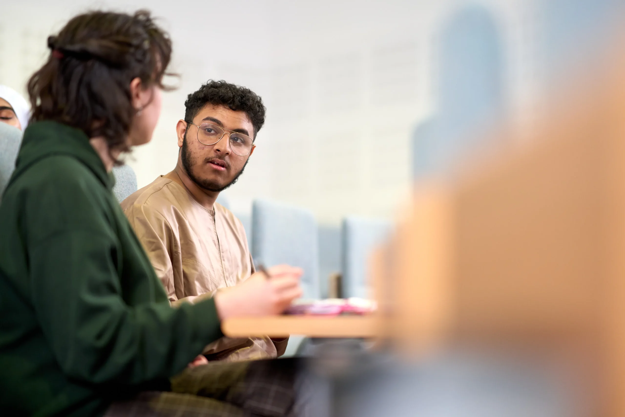 What MBA skills do employers actually hire for- two MBA students discussing business at a desk