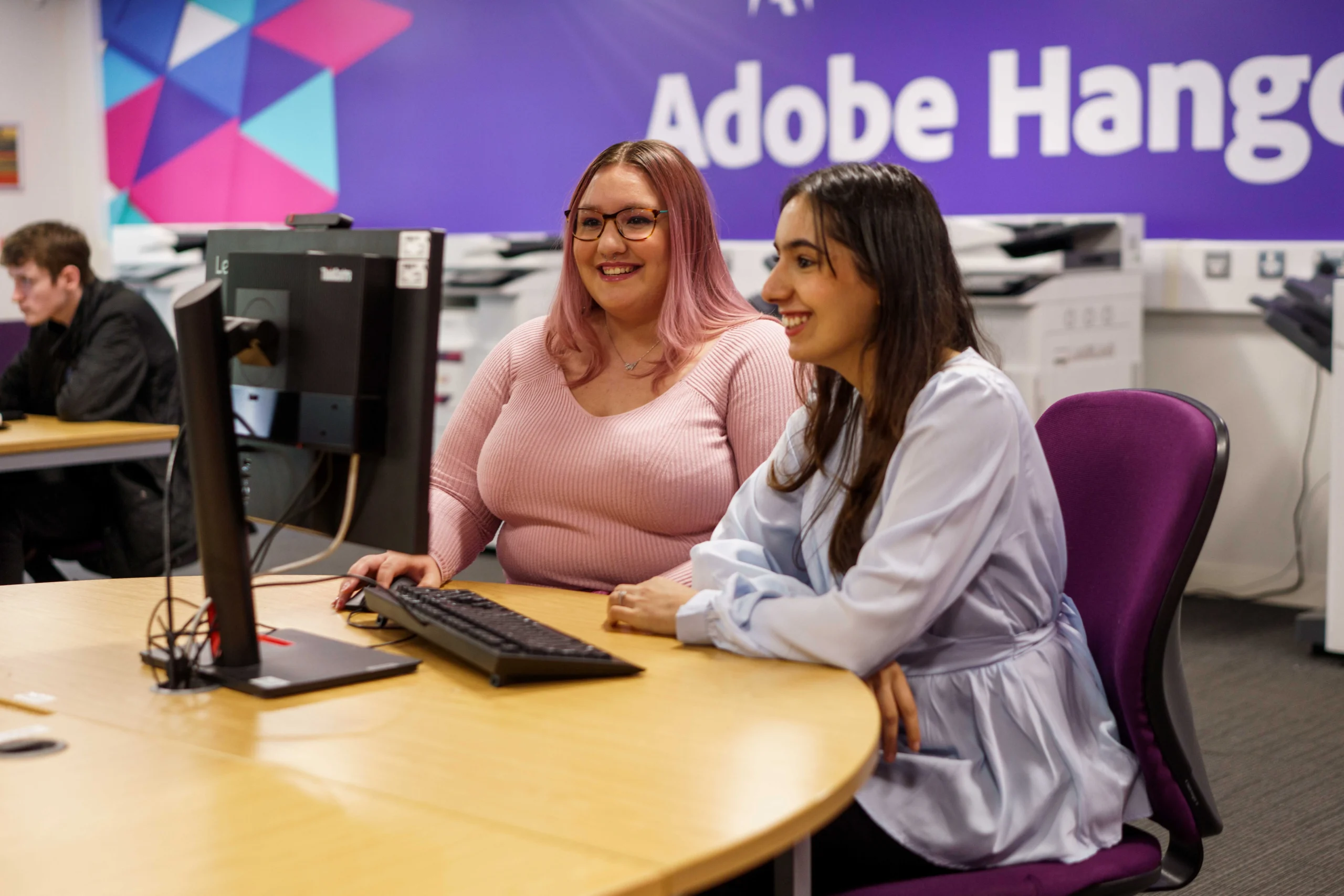 What can you do with an Aston LLB Hons (Online) degree? - two women co-working at a round table in a communal work space