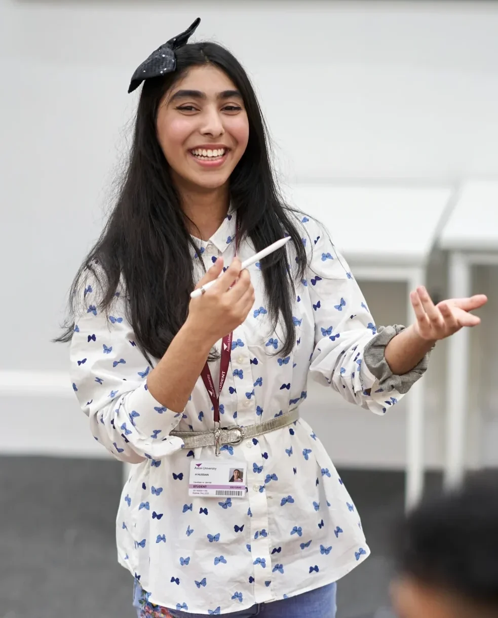 Study at Aston Online - woman pointing to download brochure on the right