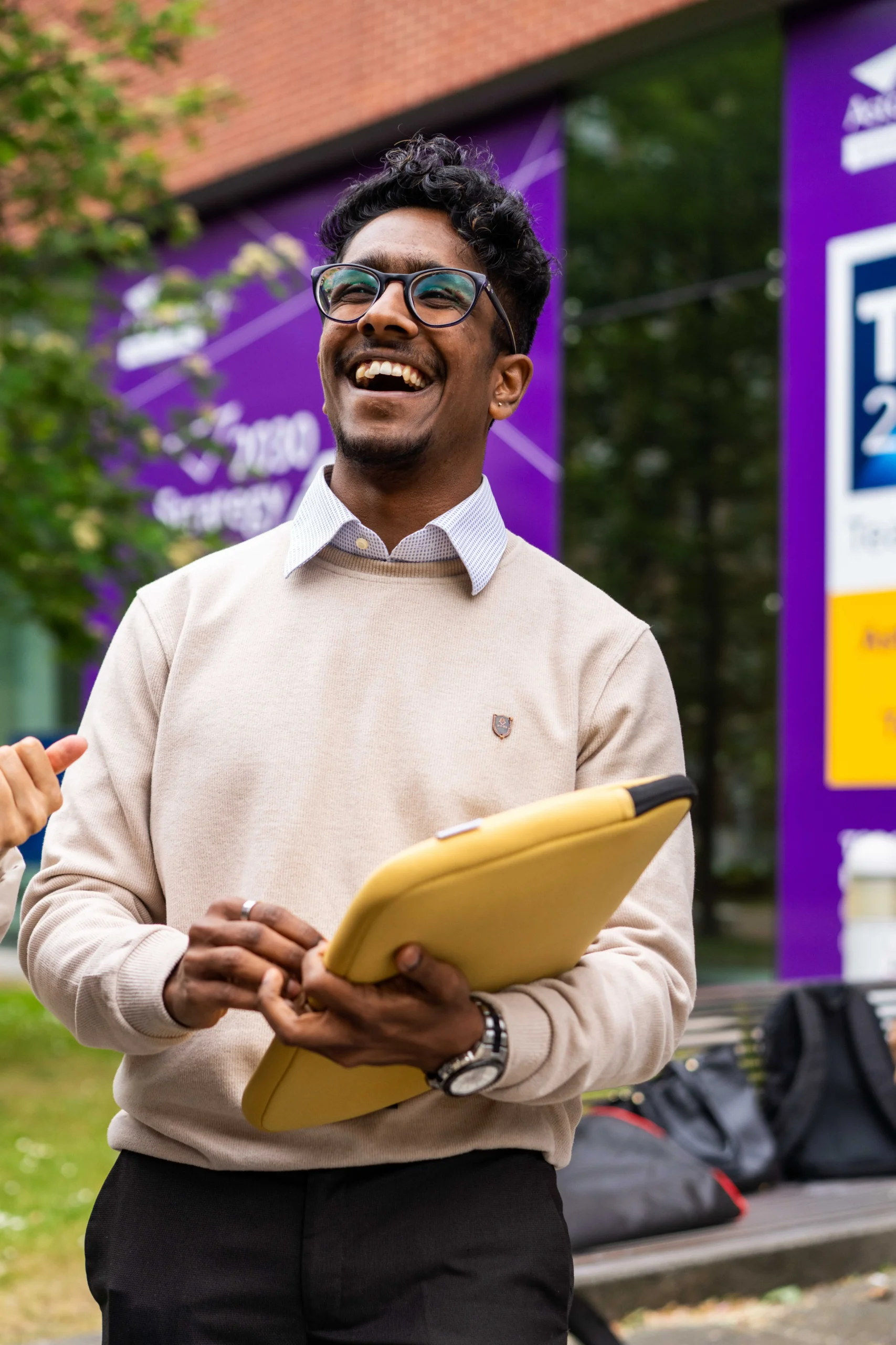 Aston Online - Student Finance Wales application process - man smiling with a laptop in his hand