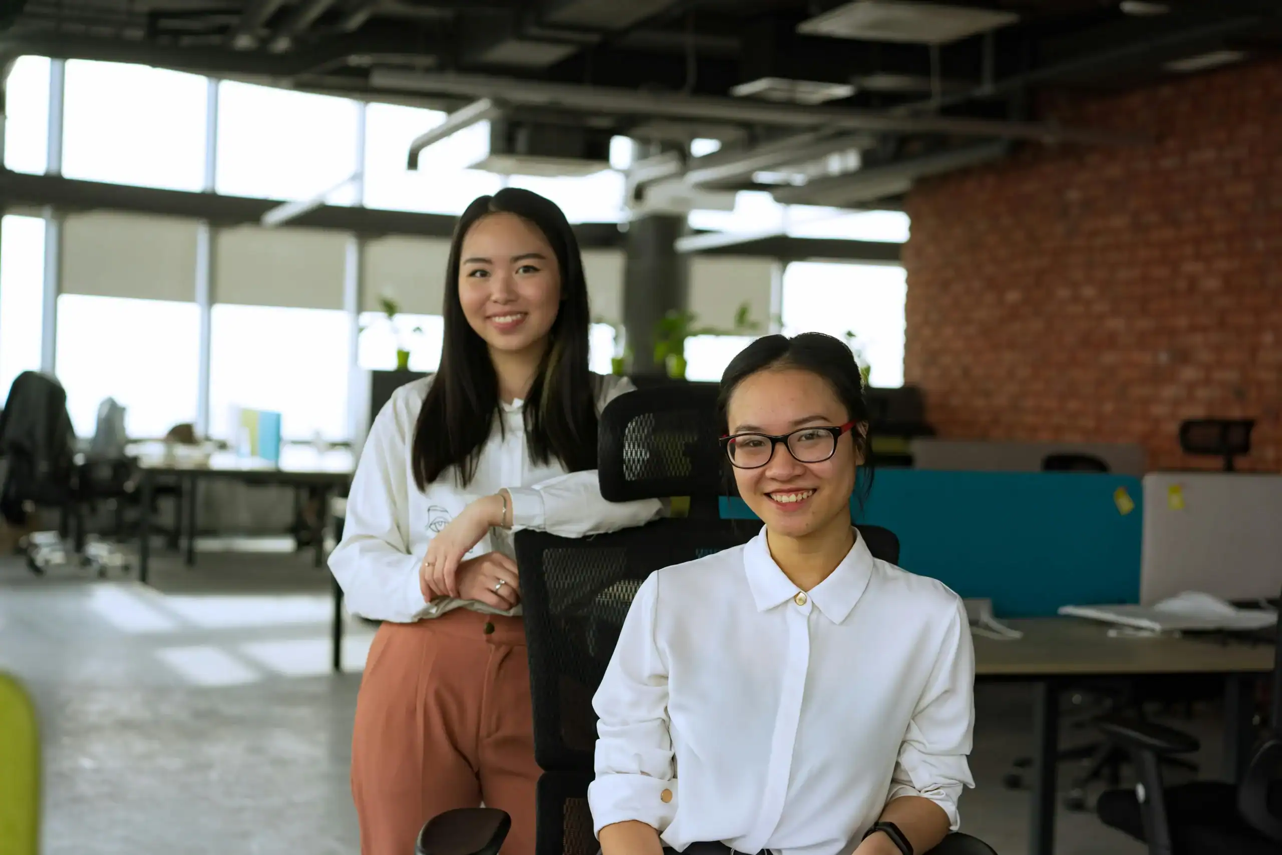Aston Online Thank You Interest - two professional female colleagues sitting in office smiling
